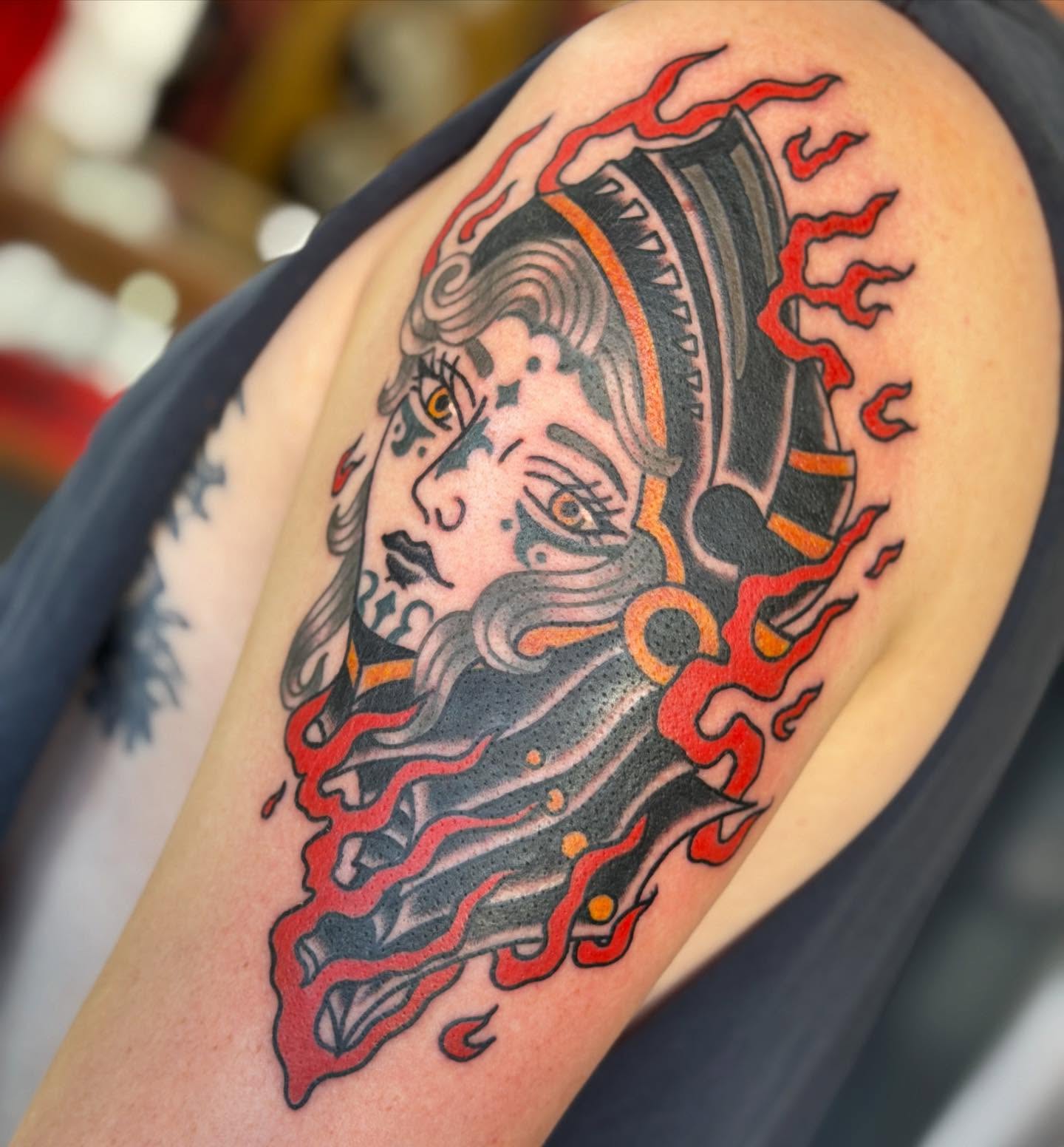 Bearded man with flames American traditional tattoo on the shoulder by April Morris ⚔️ Tattoo Goblin