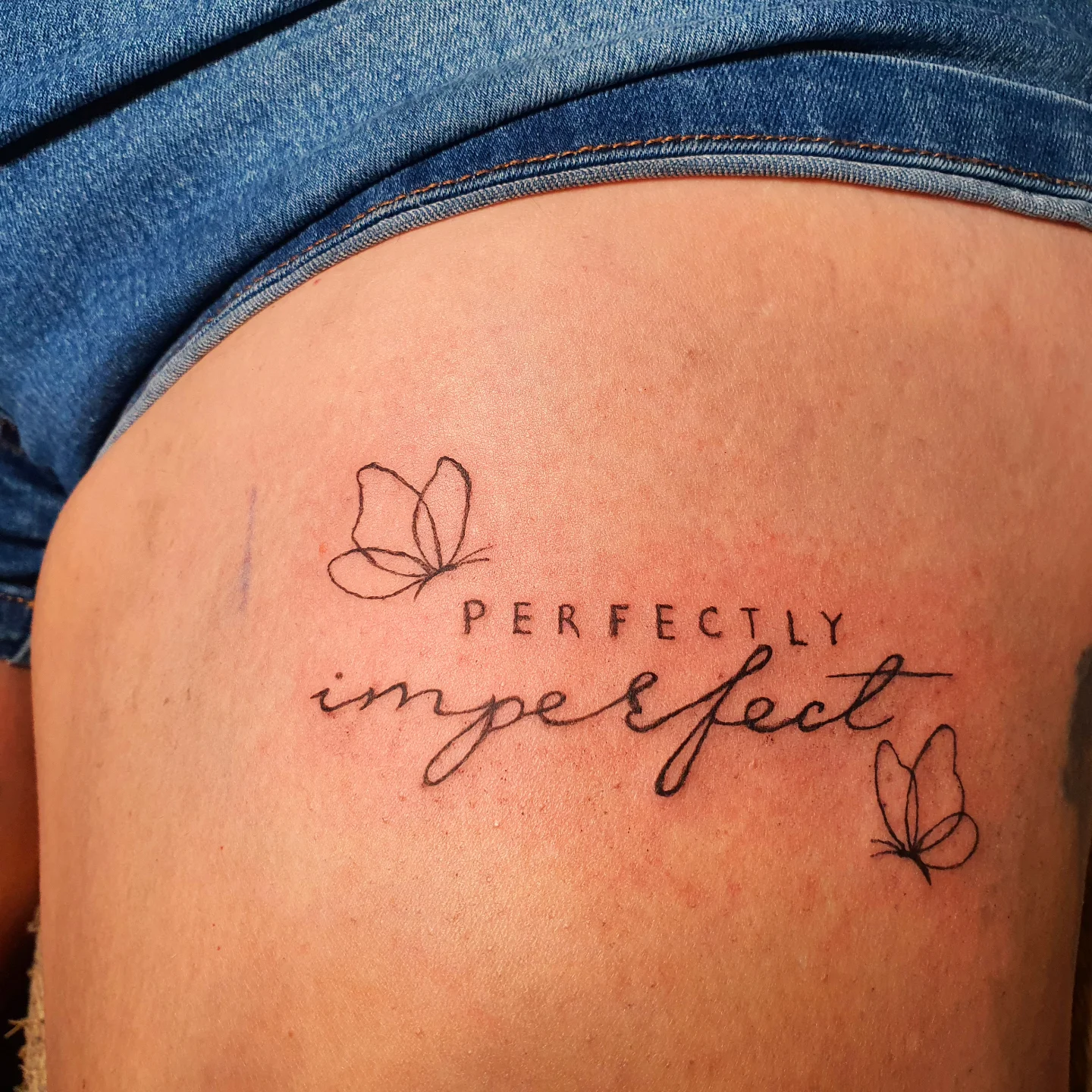 Perfectly imperfect lettering script tattoo on the thigh by Artful Ink