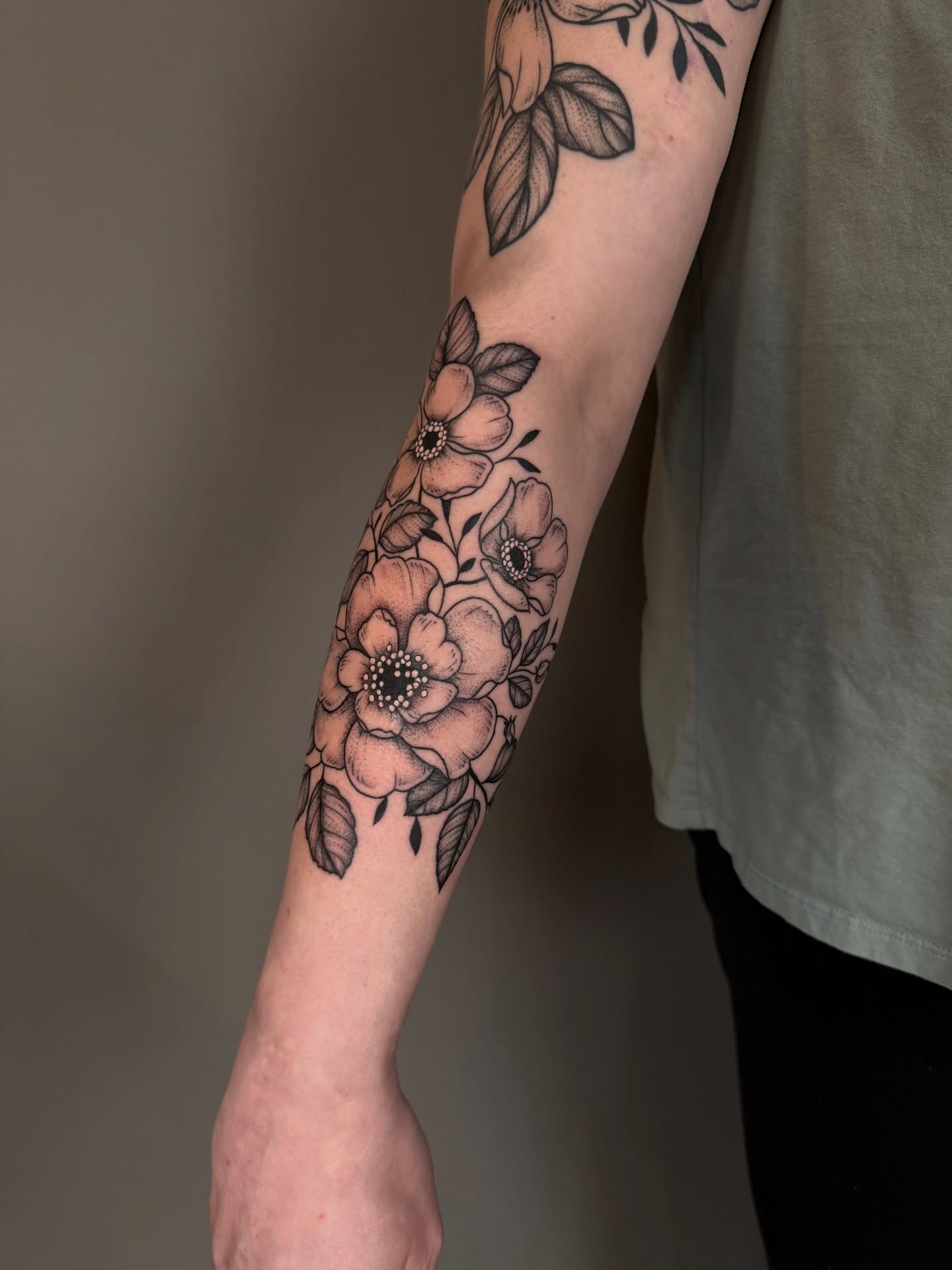 Floral bouquet black and grey tattoo on the forearm by Hannah, Portland, Oregon