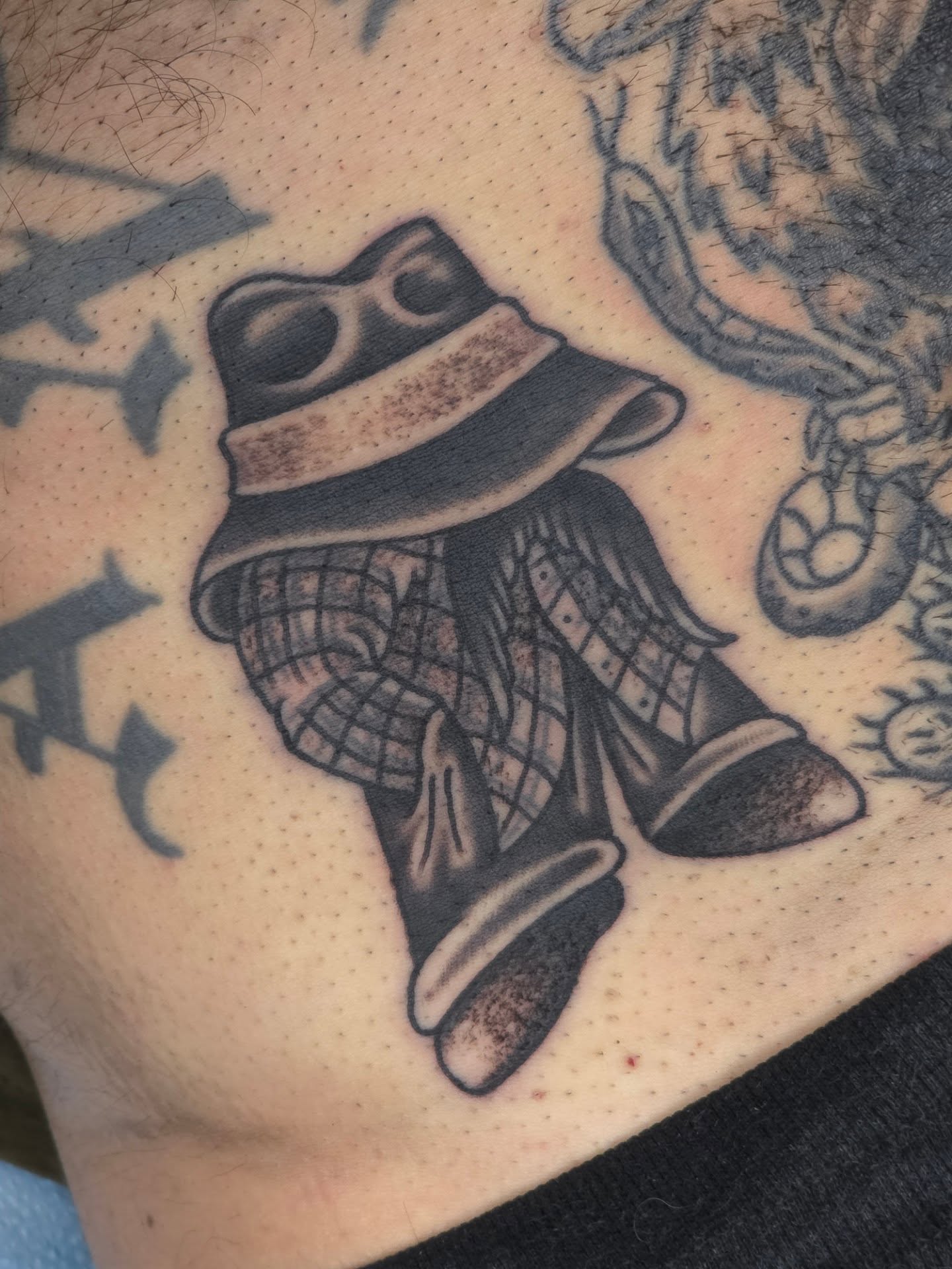 Cowboy boots American traditional tattoo on the thigh by Clayton Harpole, Jefferson, Oregon