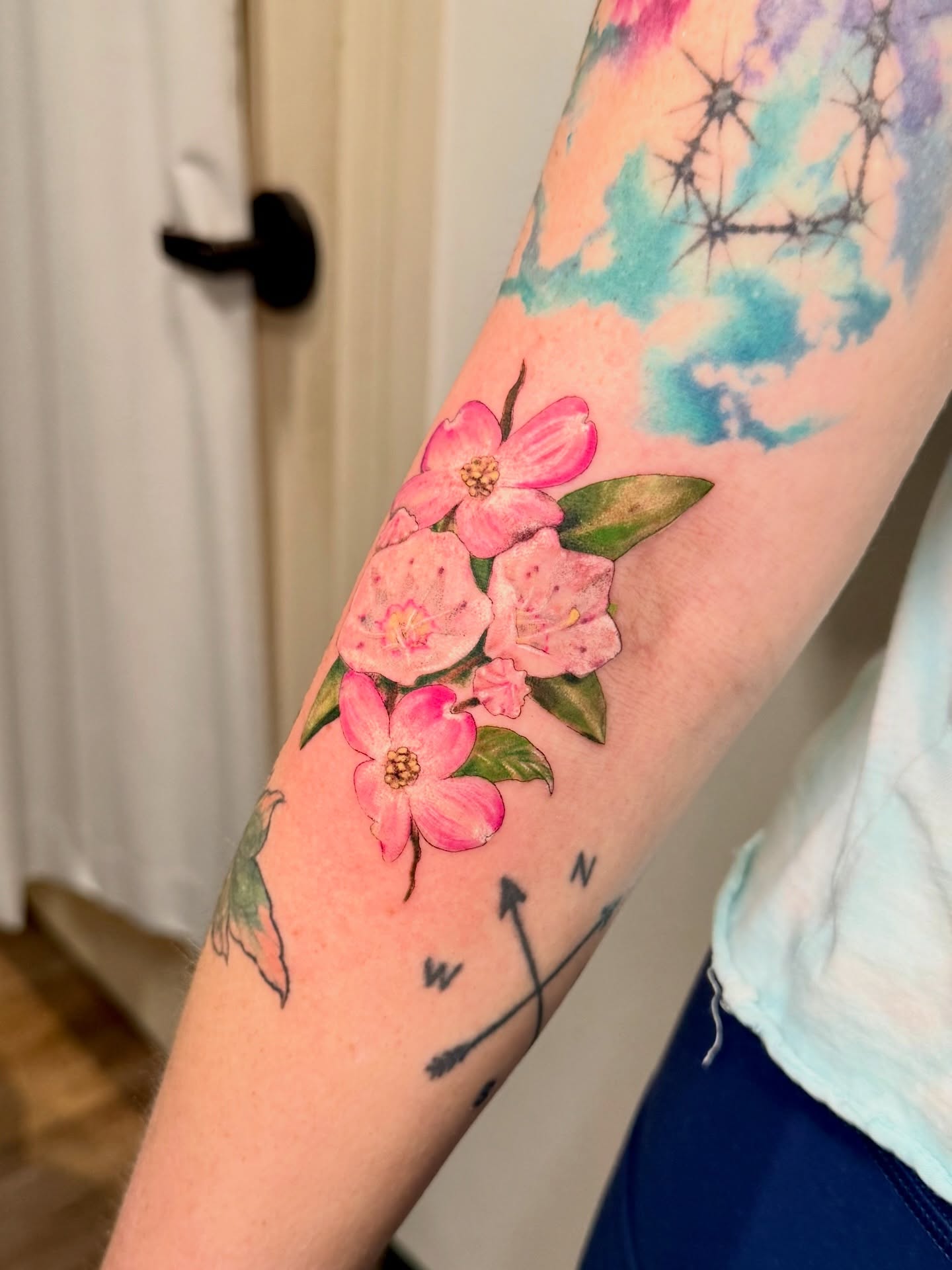 Flower bouquet watercolor tattoo on the forearm by Tatum