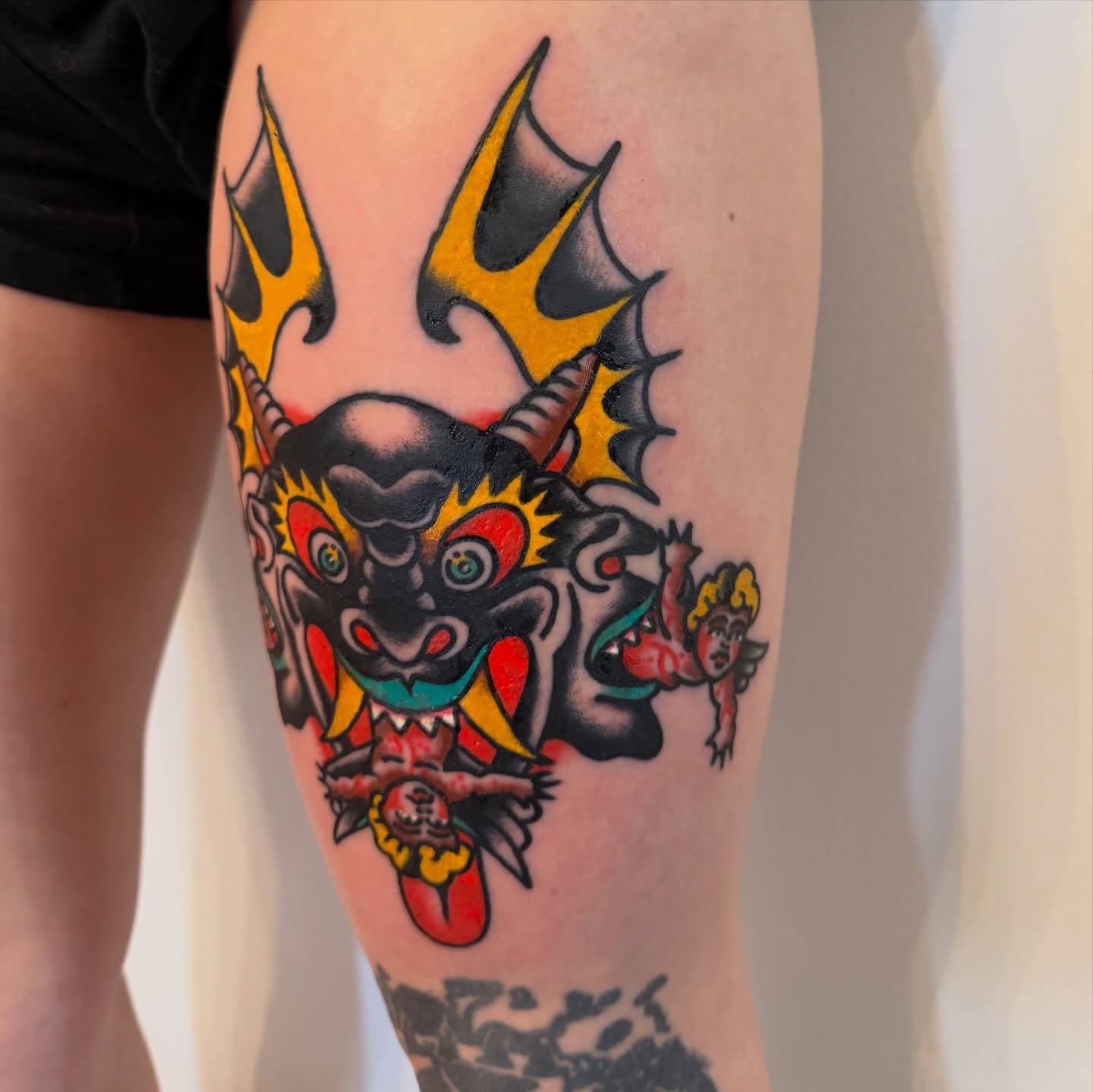 Demon with flames American traditional tattoo on the calf by Stevie Lowenstein, Cincinnati, Ohio
