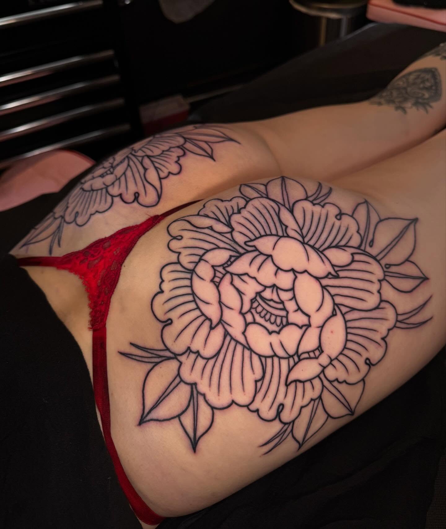 Peony black and grey tattoo on the thigh by Painted Peach Tattooer