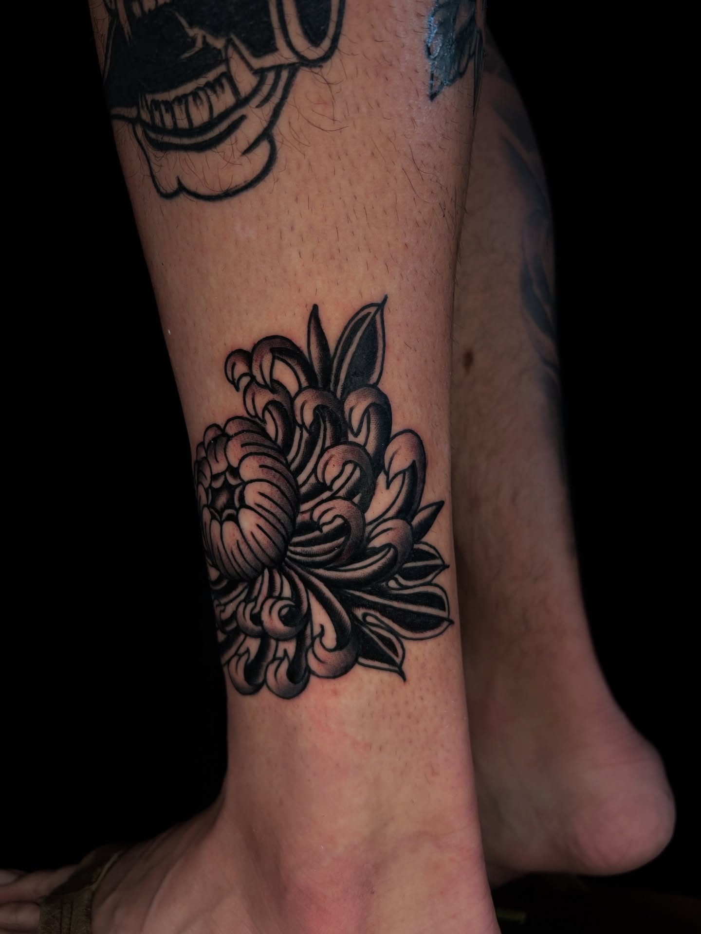 Chrysanthemum black and grey tattoo on the calf by β π€ππ©π¦π©π’π β± β