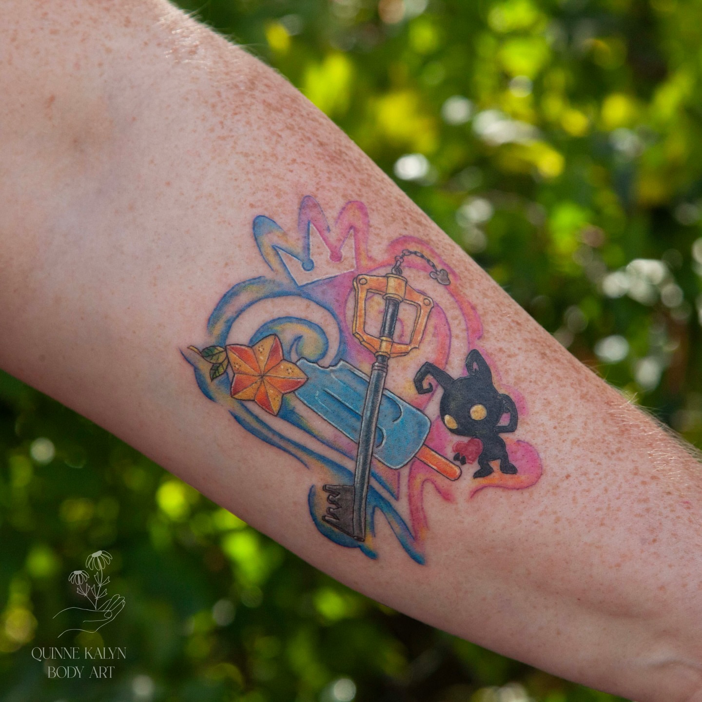 Key and character watercolor tattoo on the forearm by Nashville Piercer & Tattoo Artist ✨ Quinne