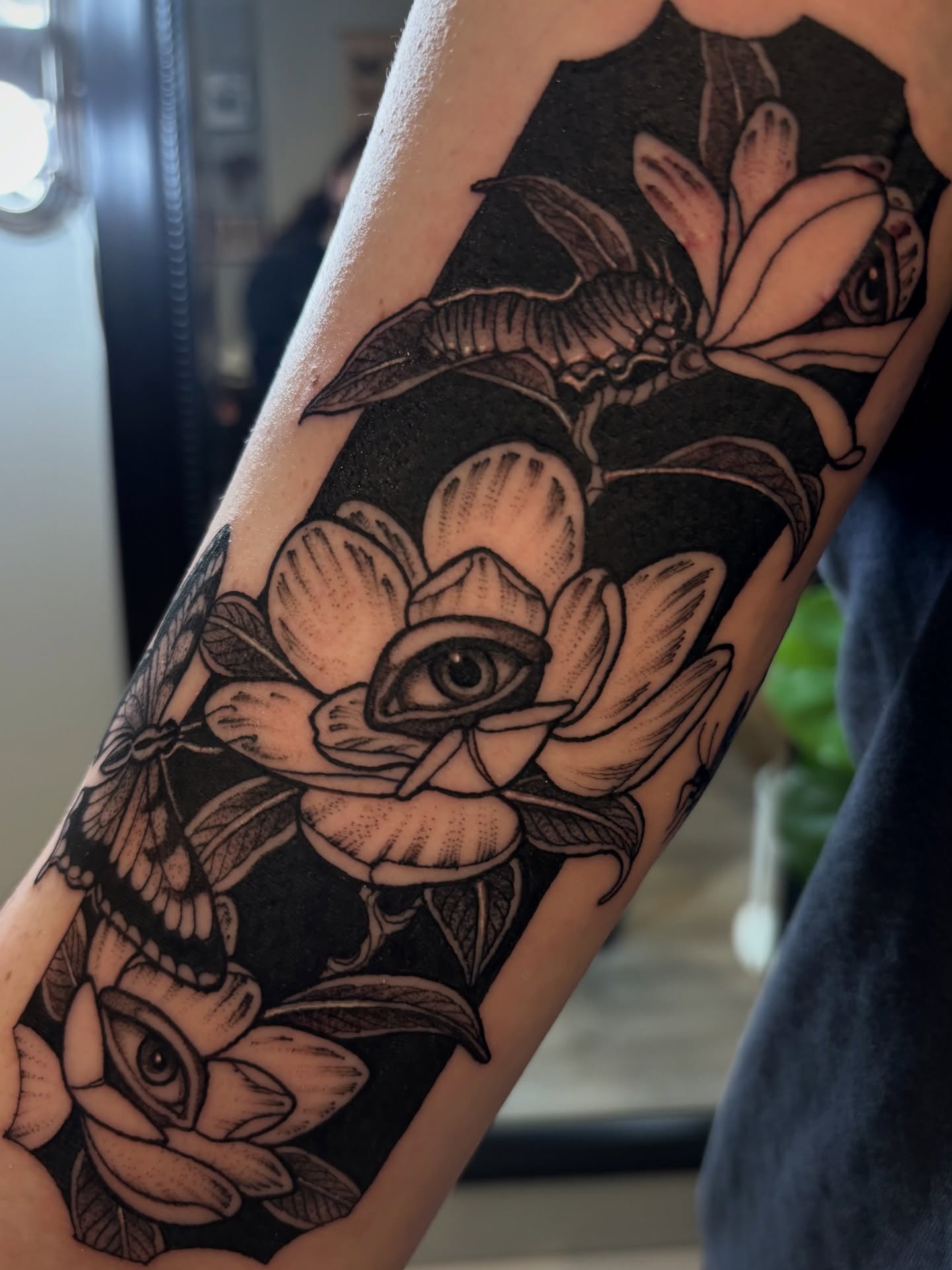 Eye and magnolia flowers American traditional tattoo on the forearm by Tara, Exeter, Pennsylvania
