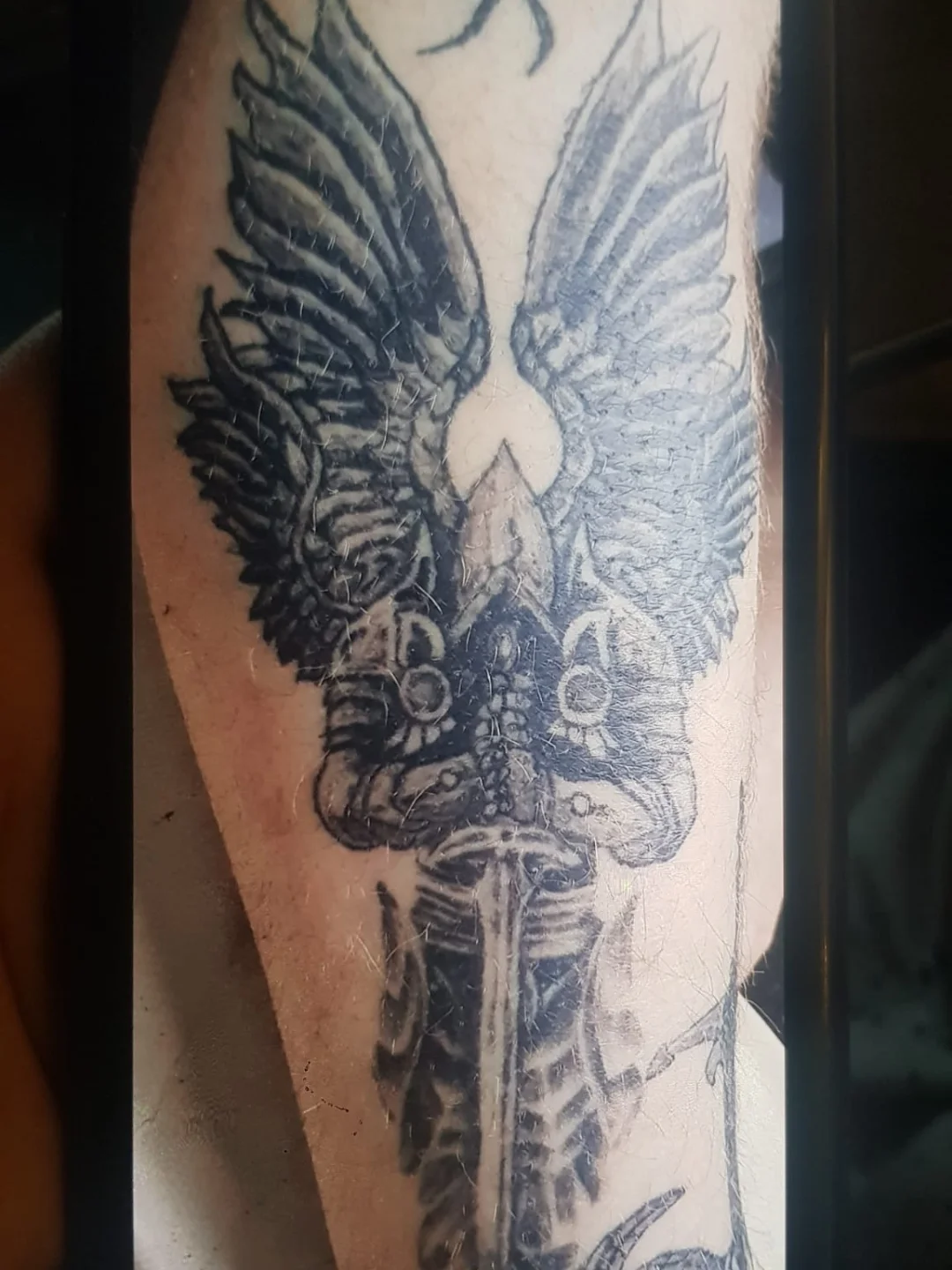 Eagle and sword realism tattoo on the forearm by Artful Ink