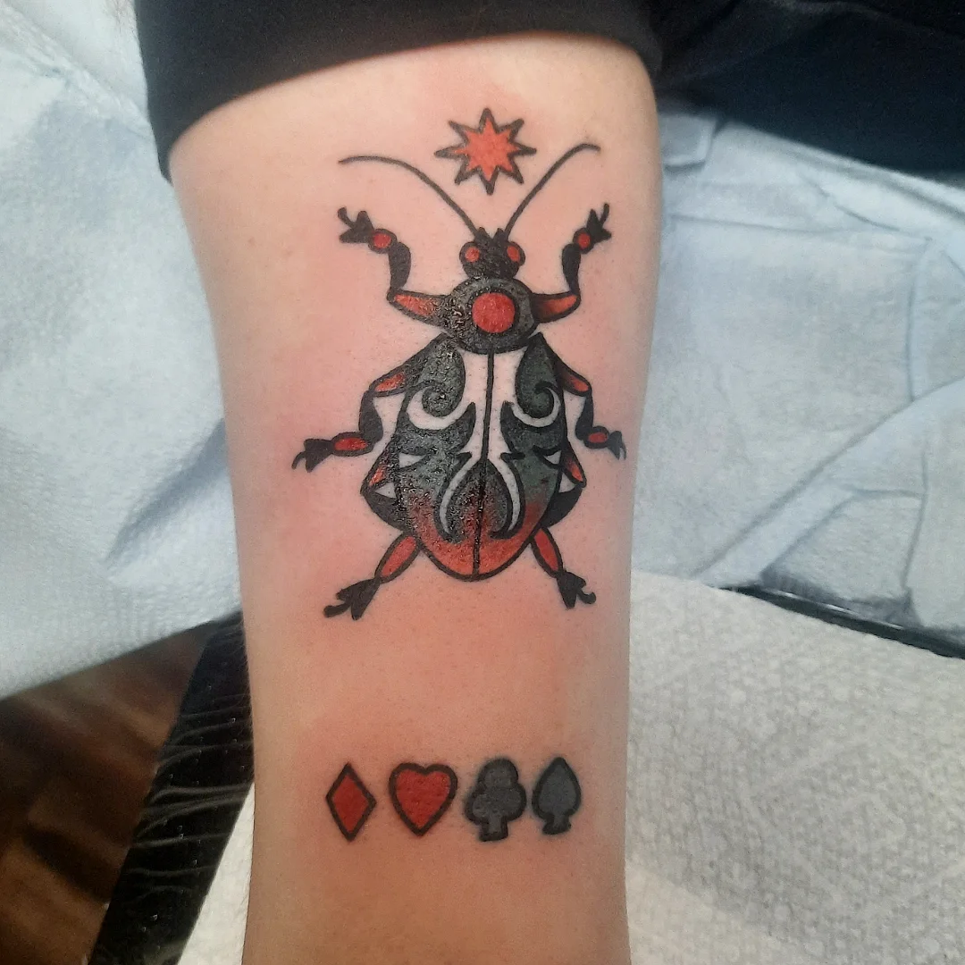 Beetle American traditional tattoo on the forearm by Kaetlyn