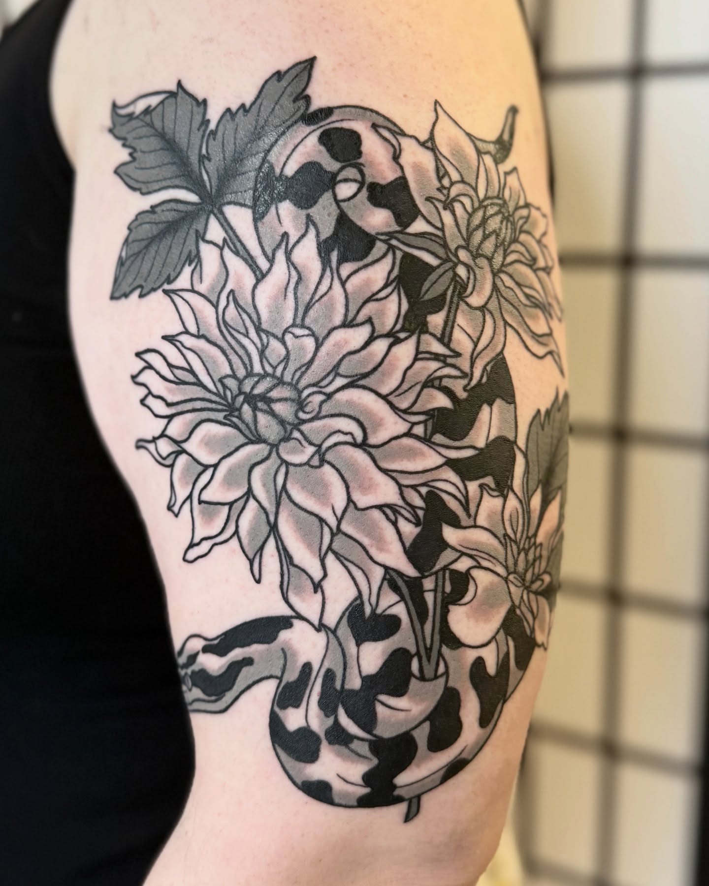Flower and snake black and grey tattoo on the forearm by Nia (Knee-uhh) 🦷