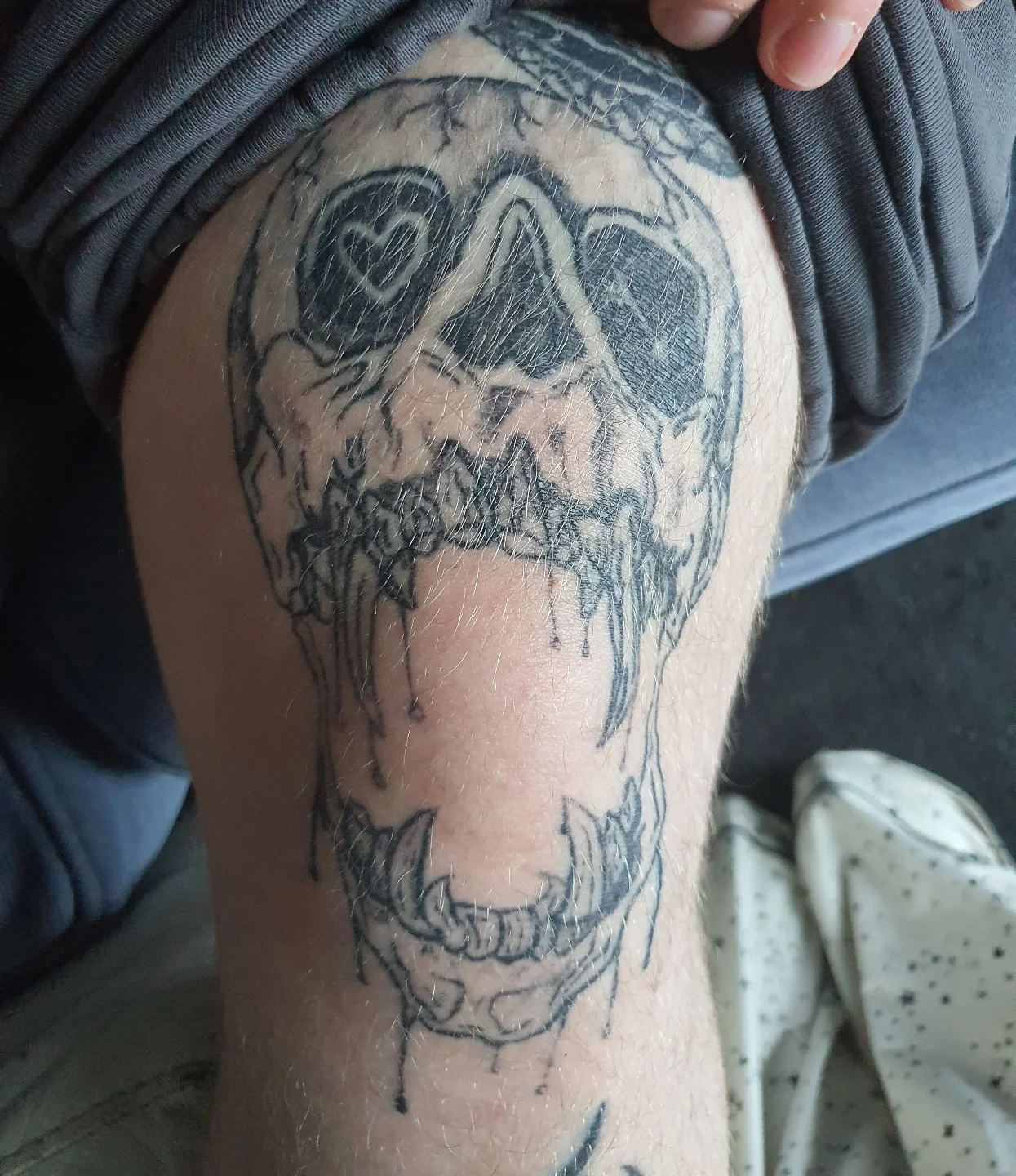 Skull black and grey tattoo on the thigh by Artful Ink