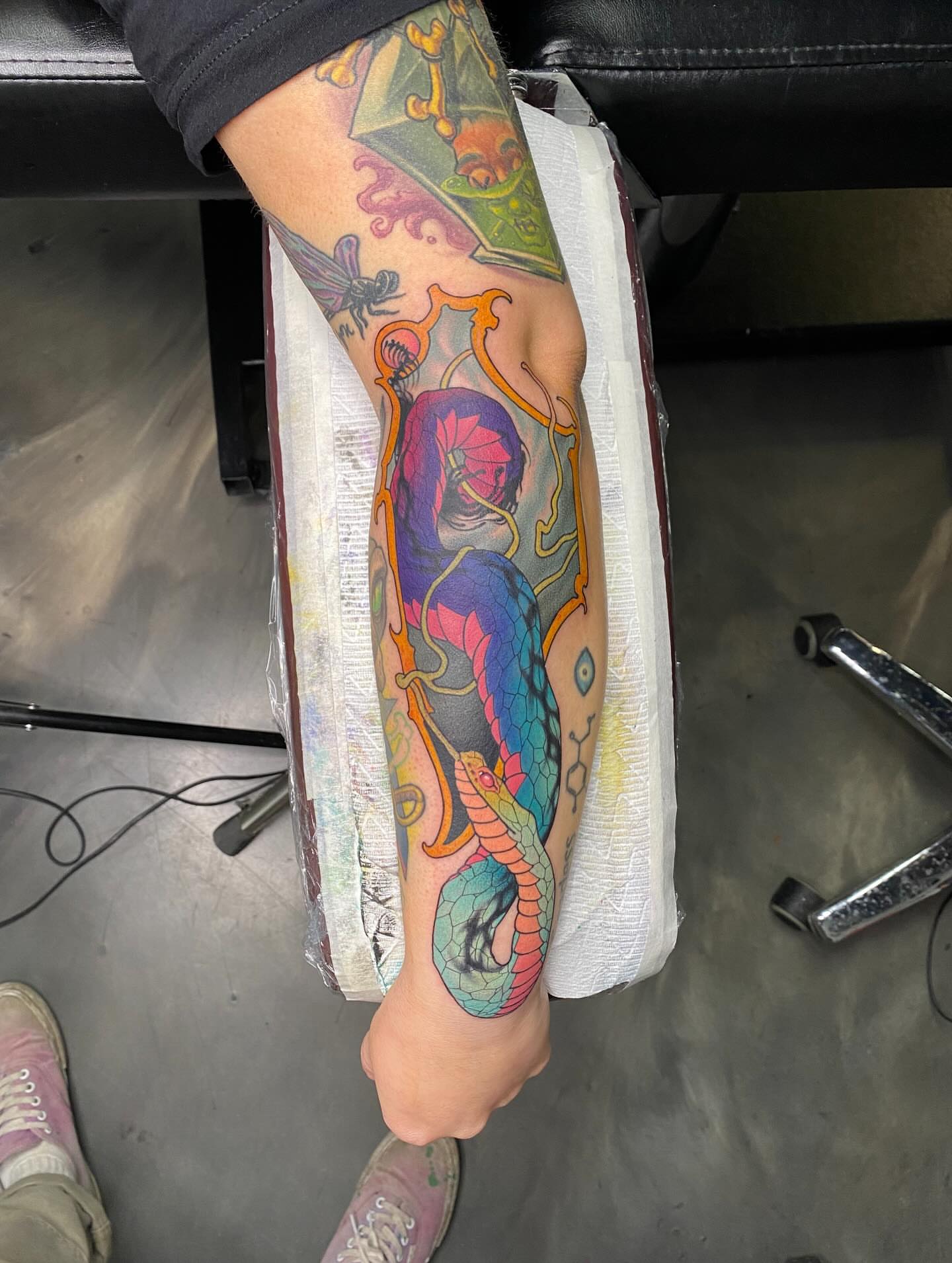 Snake and peony new school tattoo on the forearm by Kyle Kozek, Columbus, Ohio