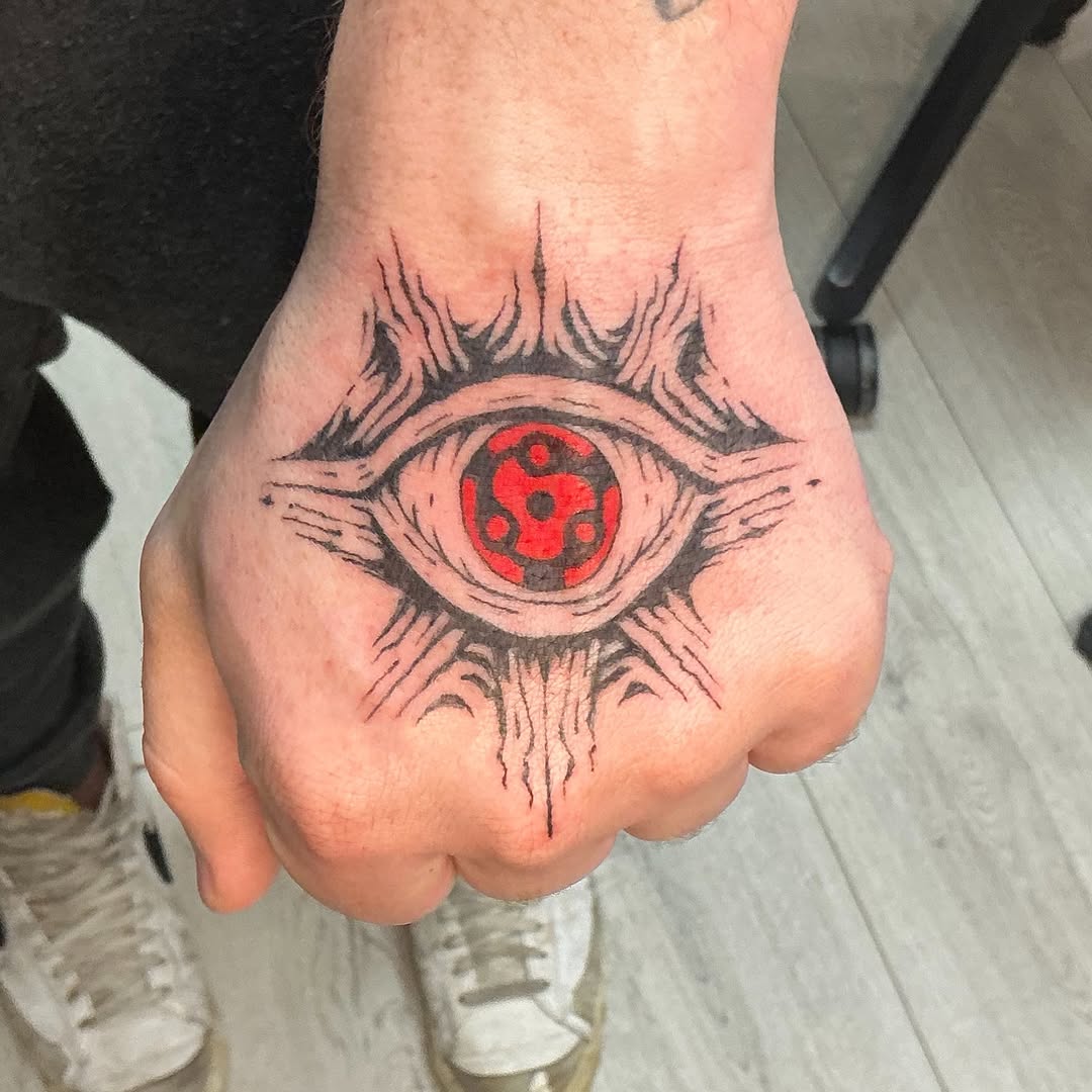 Sharingan eye anime tattoo on the hand by Isaac Mccavitt
