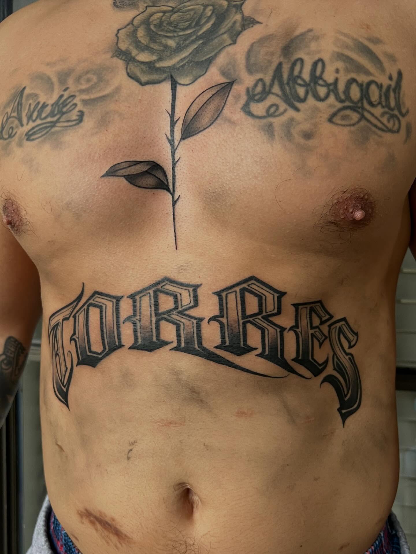 Rose and name black and grey tattoo on the chest by Dallas tx tattoo artist ✝️