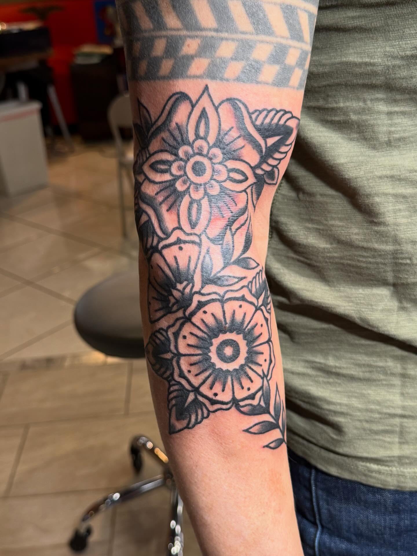 Floral American traditional tattoo on the forearm by Bill Crawford, Plymouth, Michigan