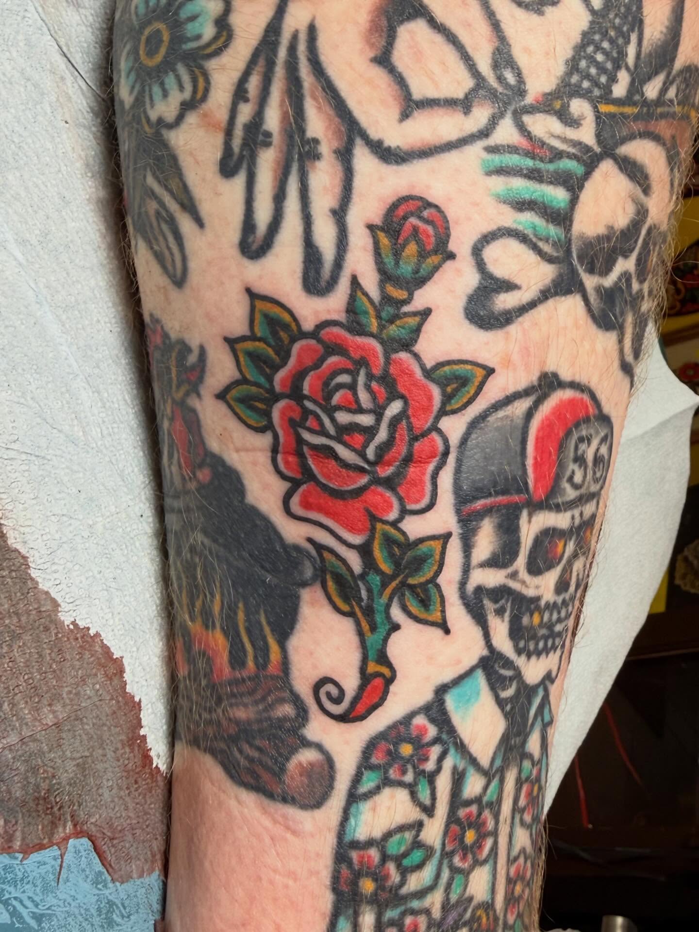 Rose and skull American traditional tattoo on the forearm by Bill Crawford, Plymouth, Michigan