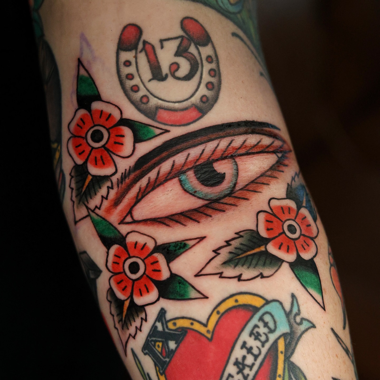 Eye and flowers American traditional tattoo on the forearm by Dylan Mott