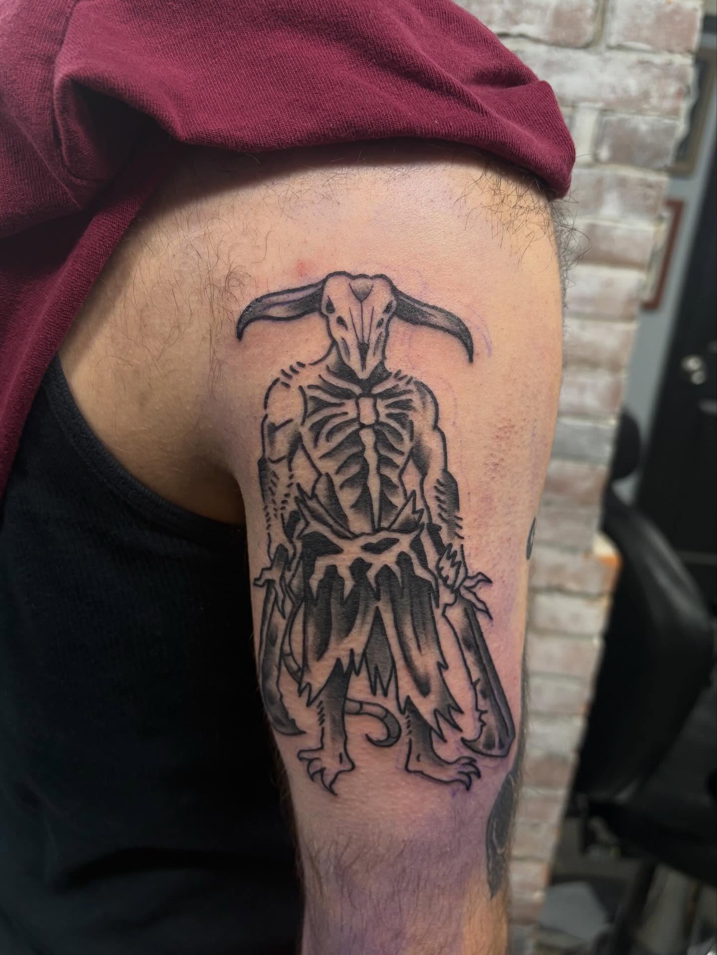 Goat-like creature black and grey tattoo on the thigh by Nolan Croteau