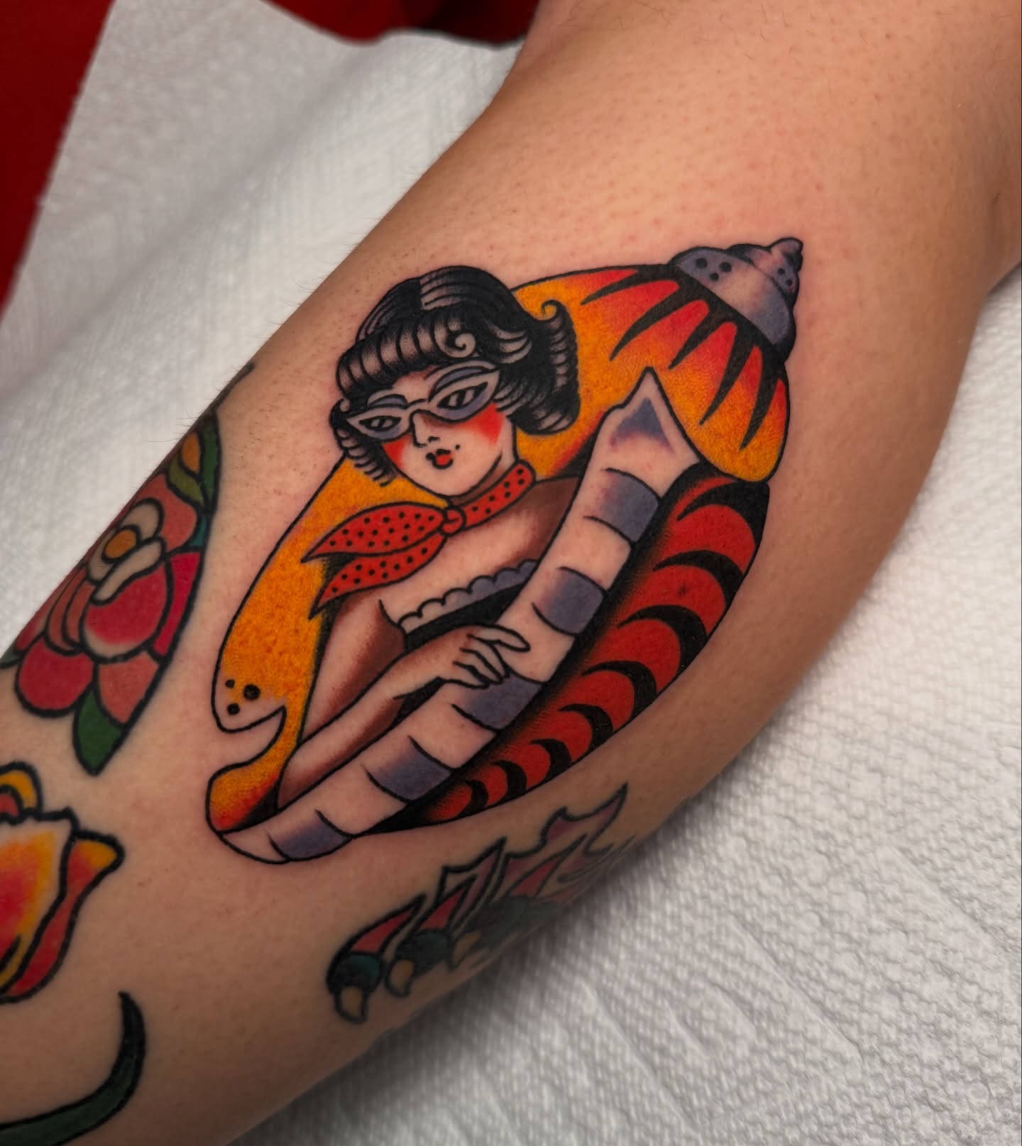 Woman in shell American traditional tattoo on the forearm by kate