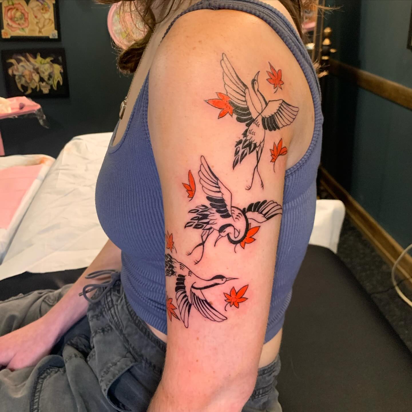 Cranes and autumn leaves American traditional tattoo on the forearm by Hannah Hahn