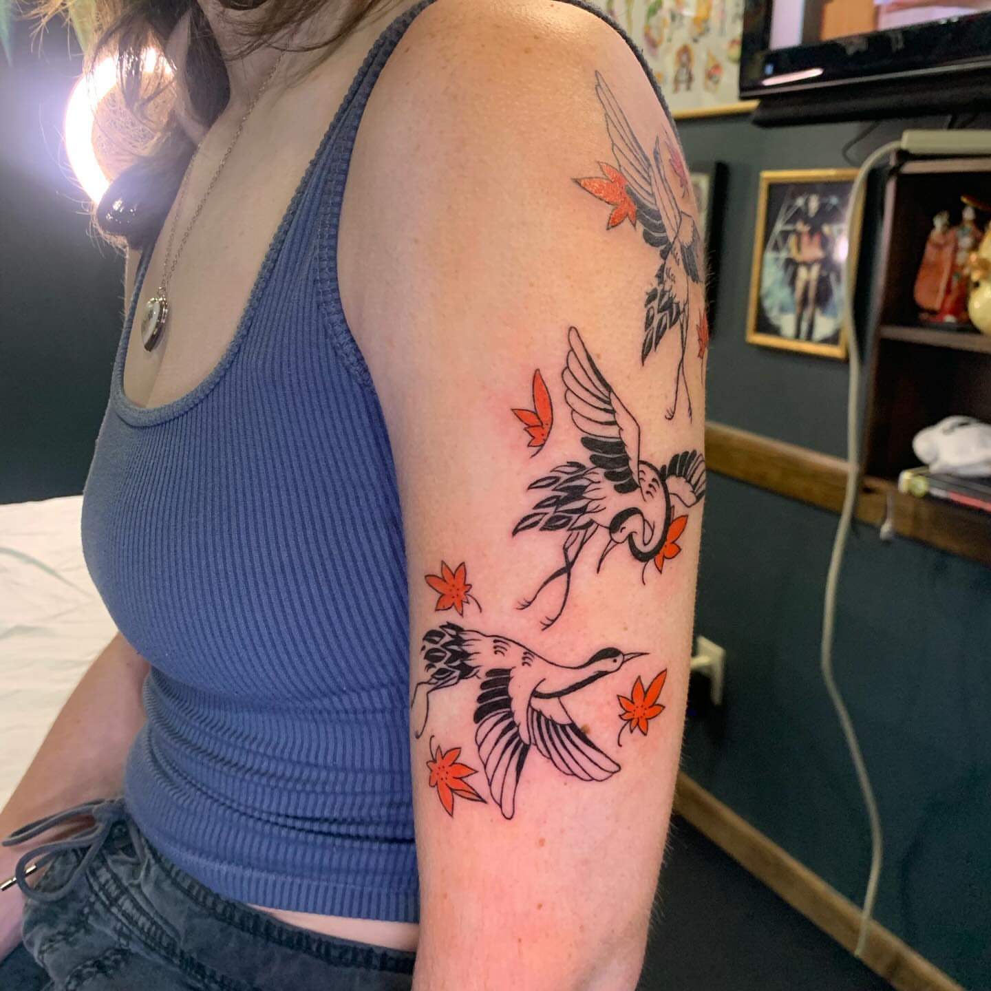 Cranes and maple leaves American traditional tattoo on the forearm by Hannah Hahn