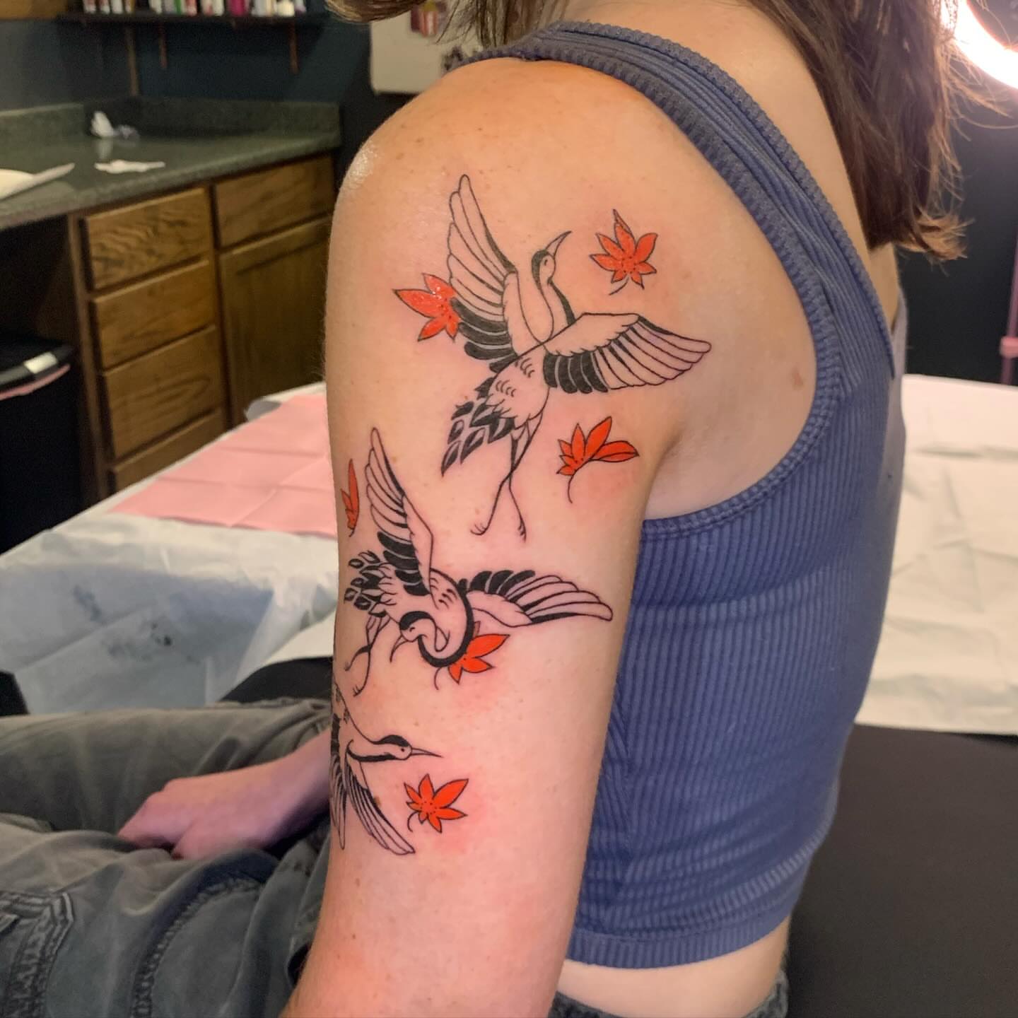Cranes and maple leaves japanese irezumi tattoo on the upper arm by Hannah Hahn