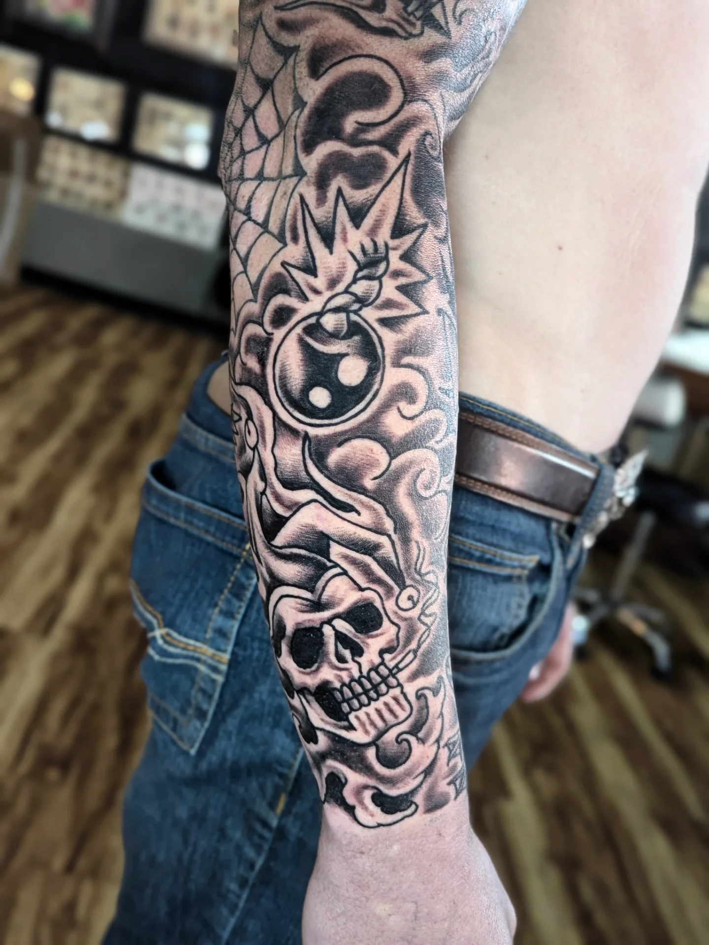 Skull and bomb realism tattoo on the forearm by Eric Ward
