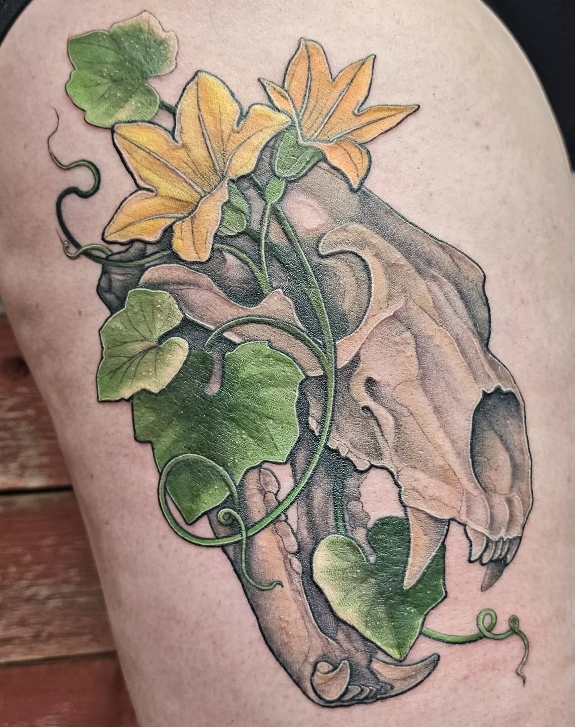 Skull with vines realism tattoo on the thigh by Savannah