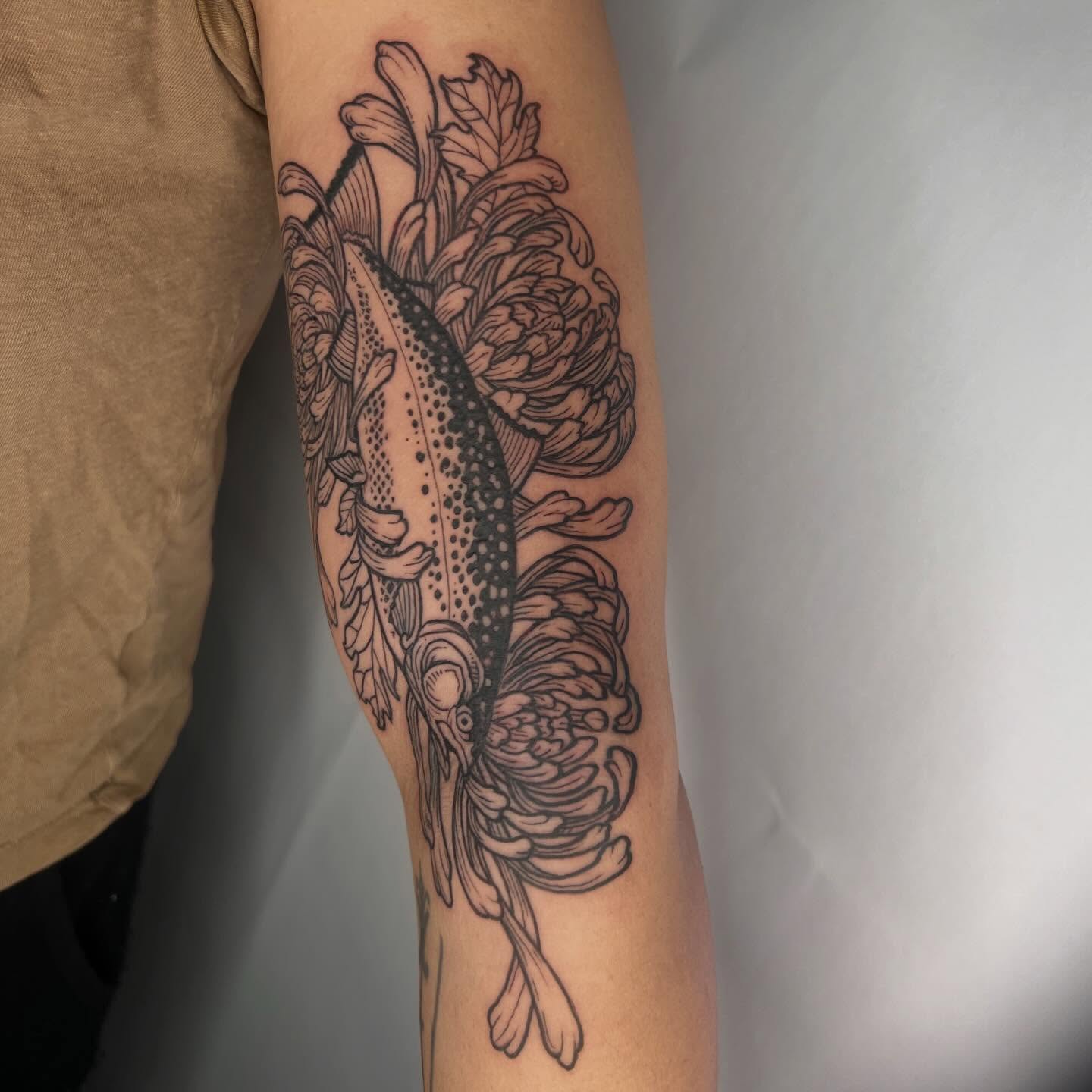 Fish and flowers dotwork tattoo on the forearm by Jason Middelton