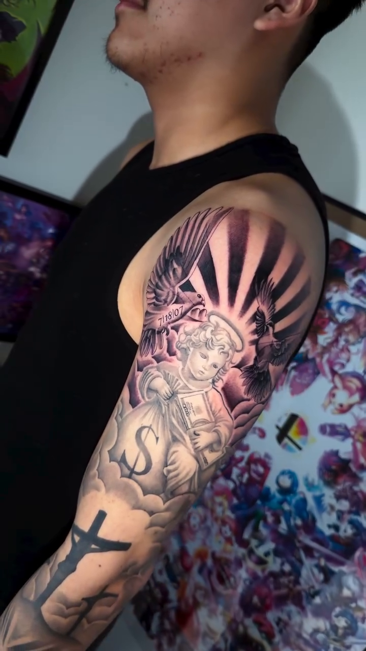 Angel with cross and sun rays realism tattoo by Danny Vazquez