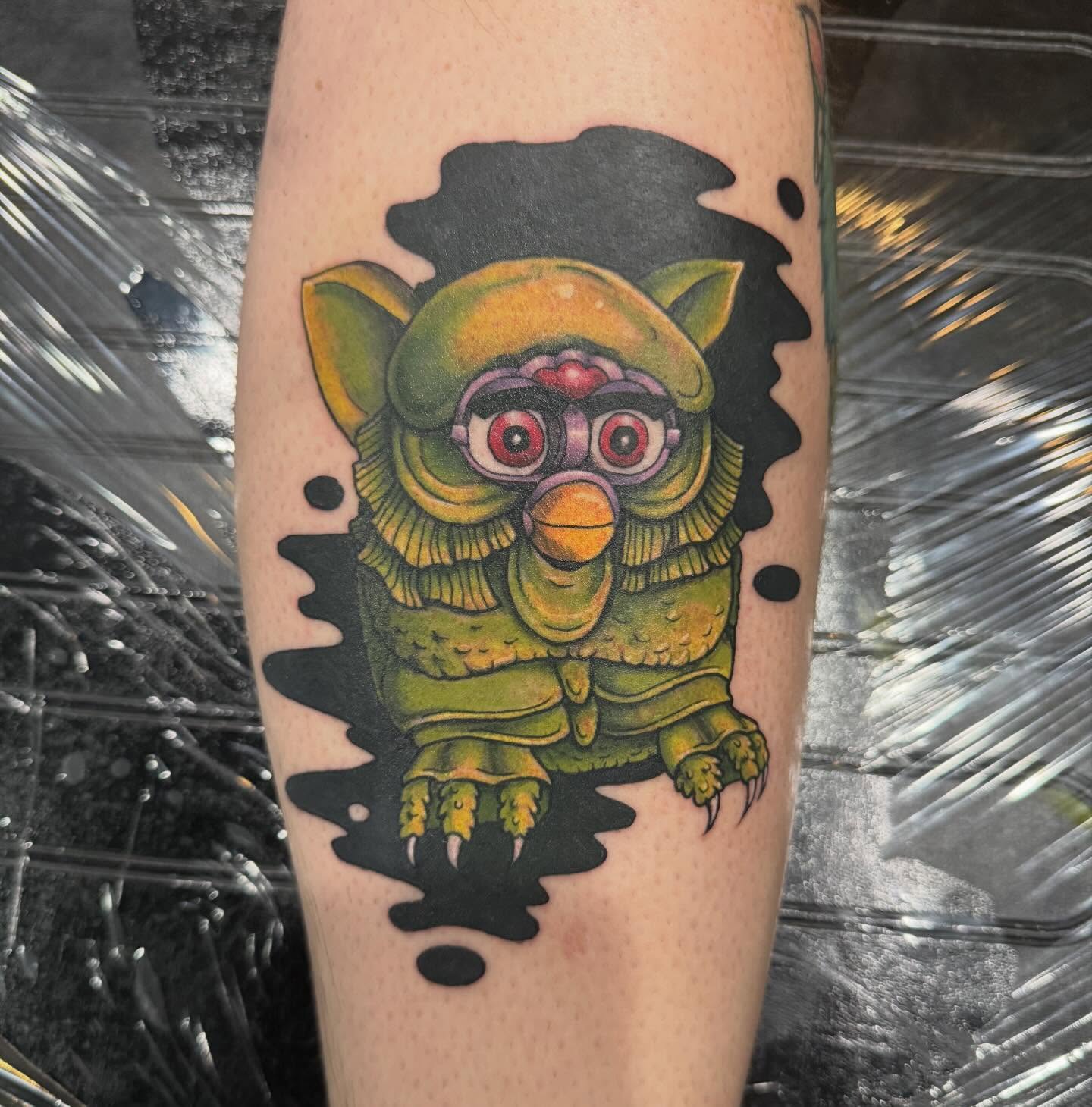 Owl-like creature new school tattoo on the forearm by Courtney