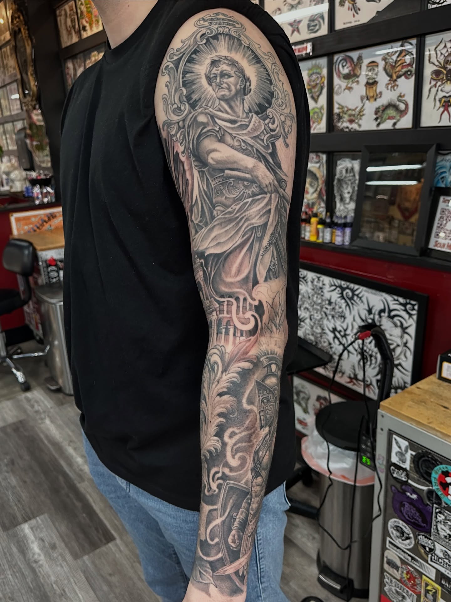 Religious figure realism tattoo on the upper arm by Skoty Fox