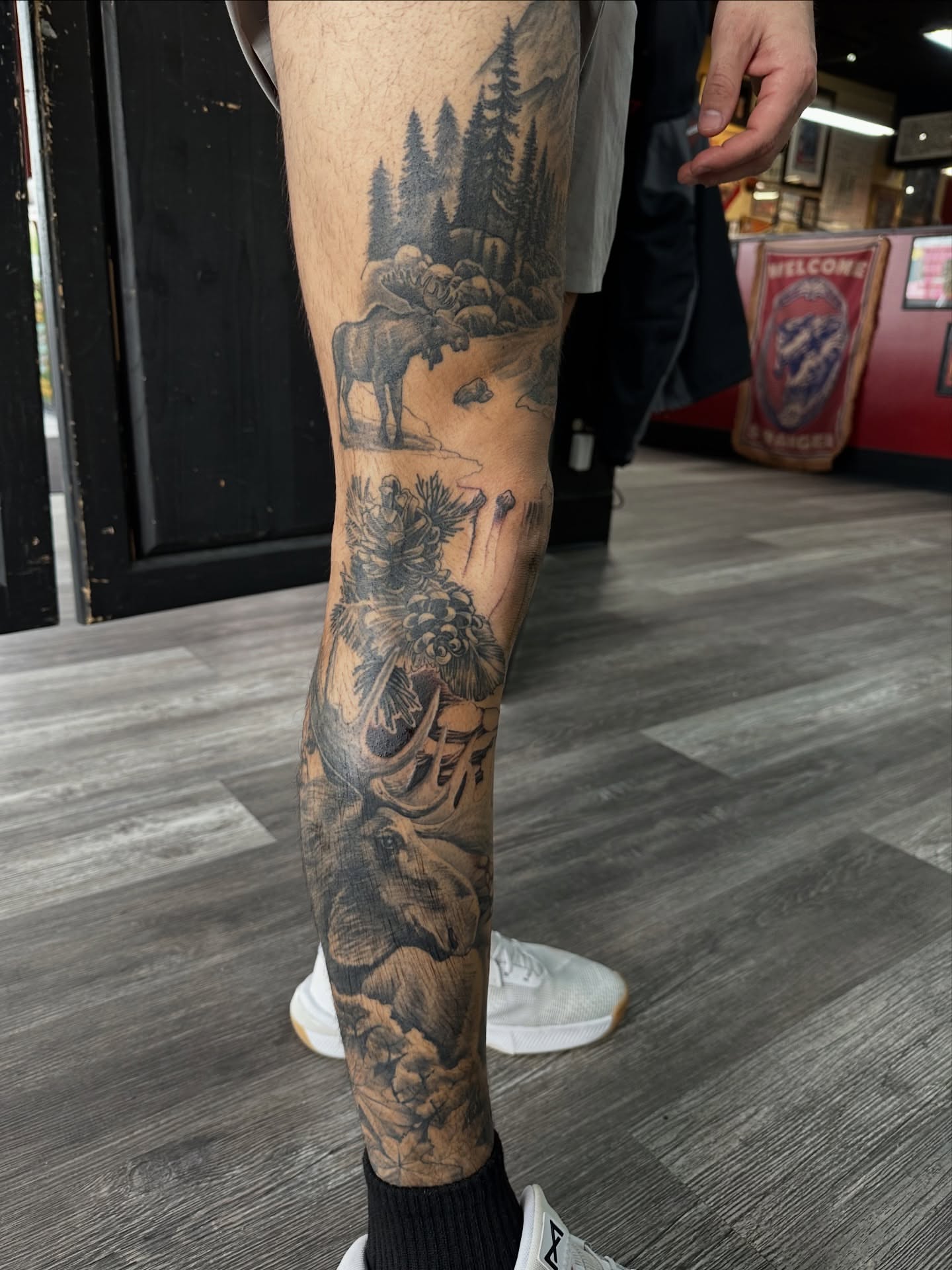 Mountain landscape realism tattoo on the calf by Skoty Fox