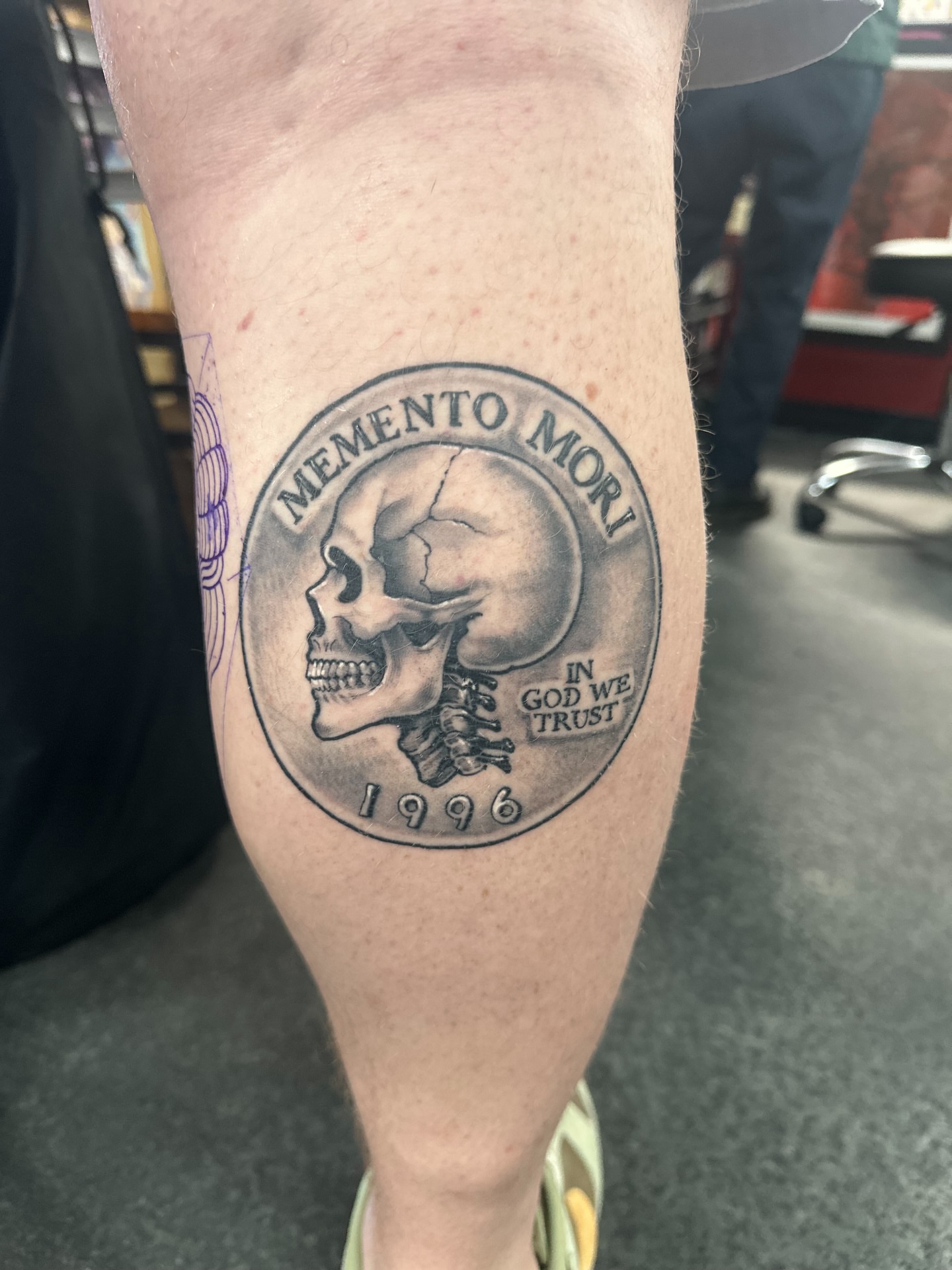 Skull black and grey tattoo on the calf by Skoty Fox