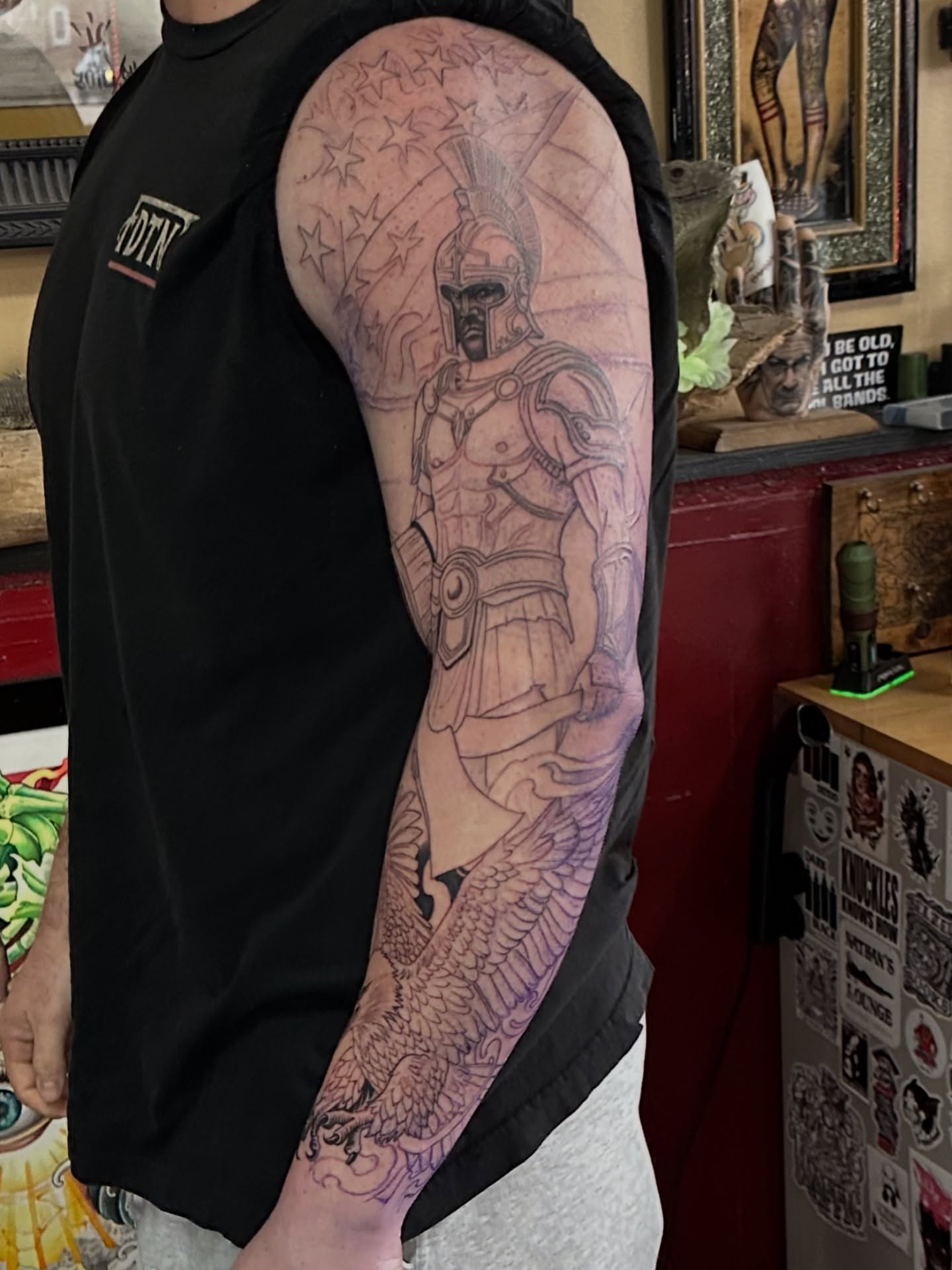 Gladiator black and grey tattoo on the upper arm by Skoty Fox