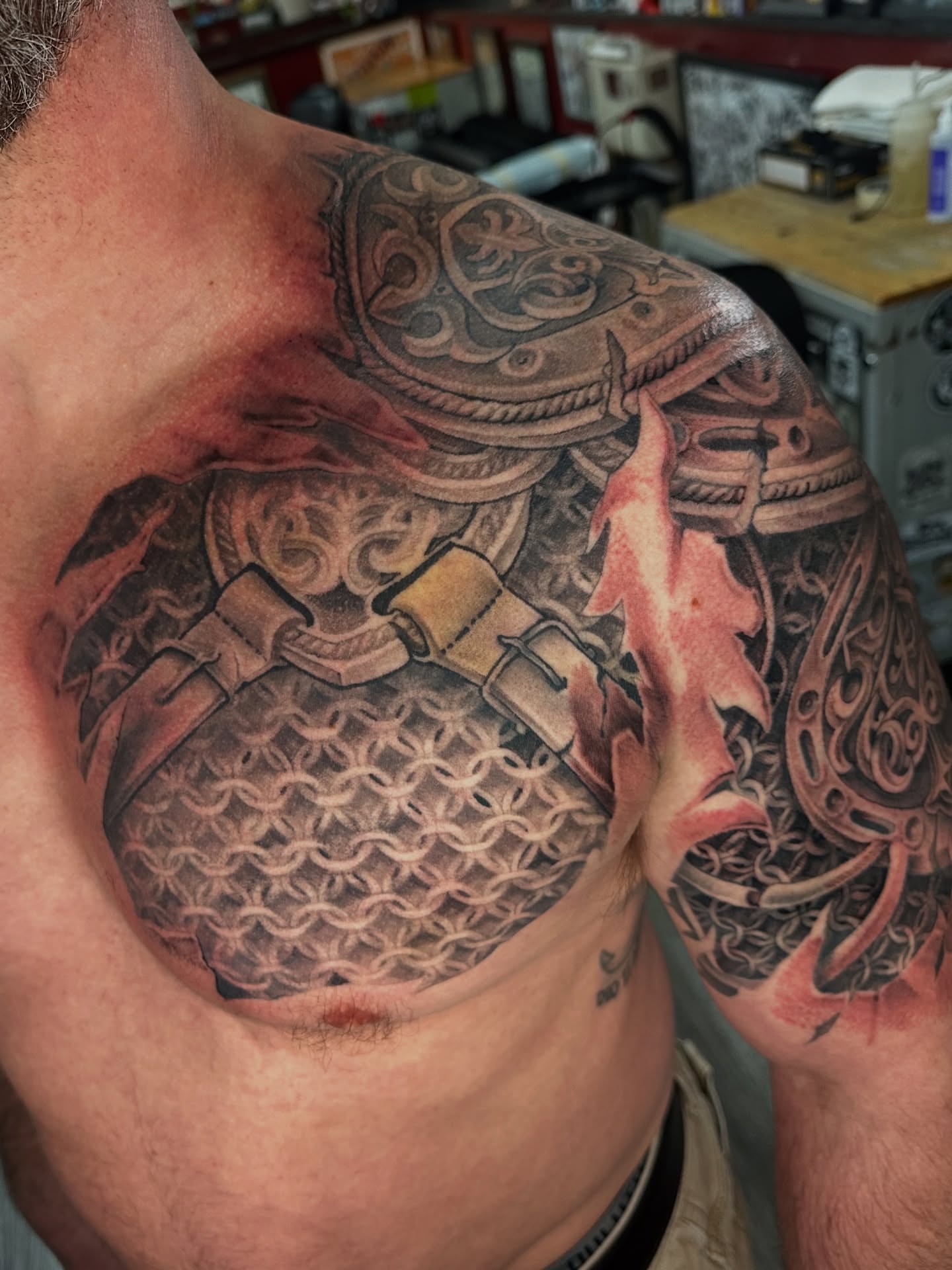 Chainmail armor realism tattoo on the chest by Skoty Fox