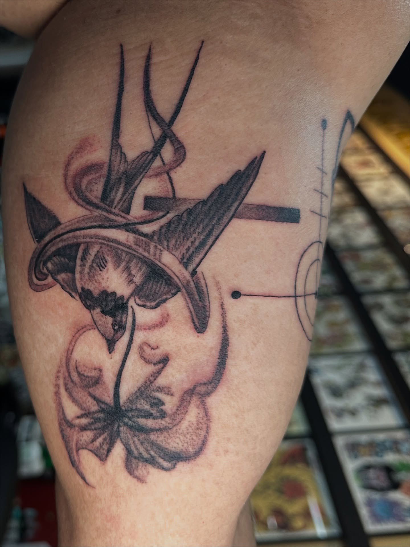 Swallow and flower realism tattoo on the thigh by Skoty Fox