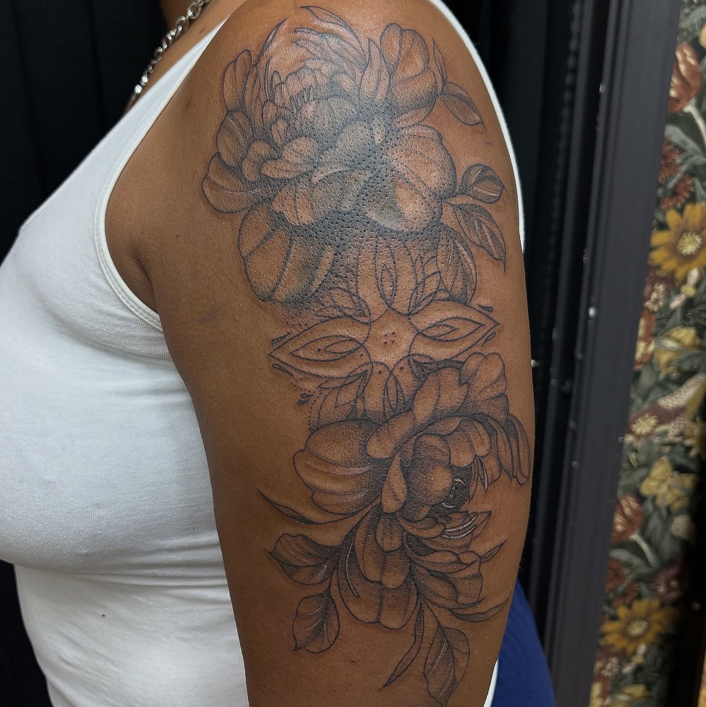 Floral arrangement black and grey tattoo on the shoulder by Sydney Gallucci