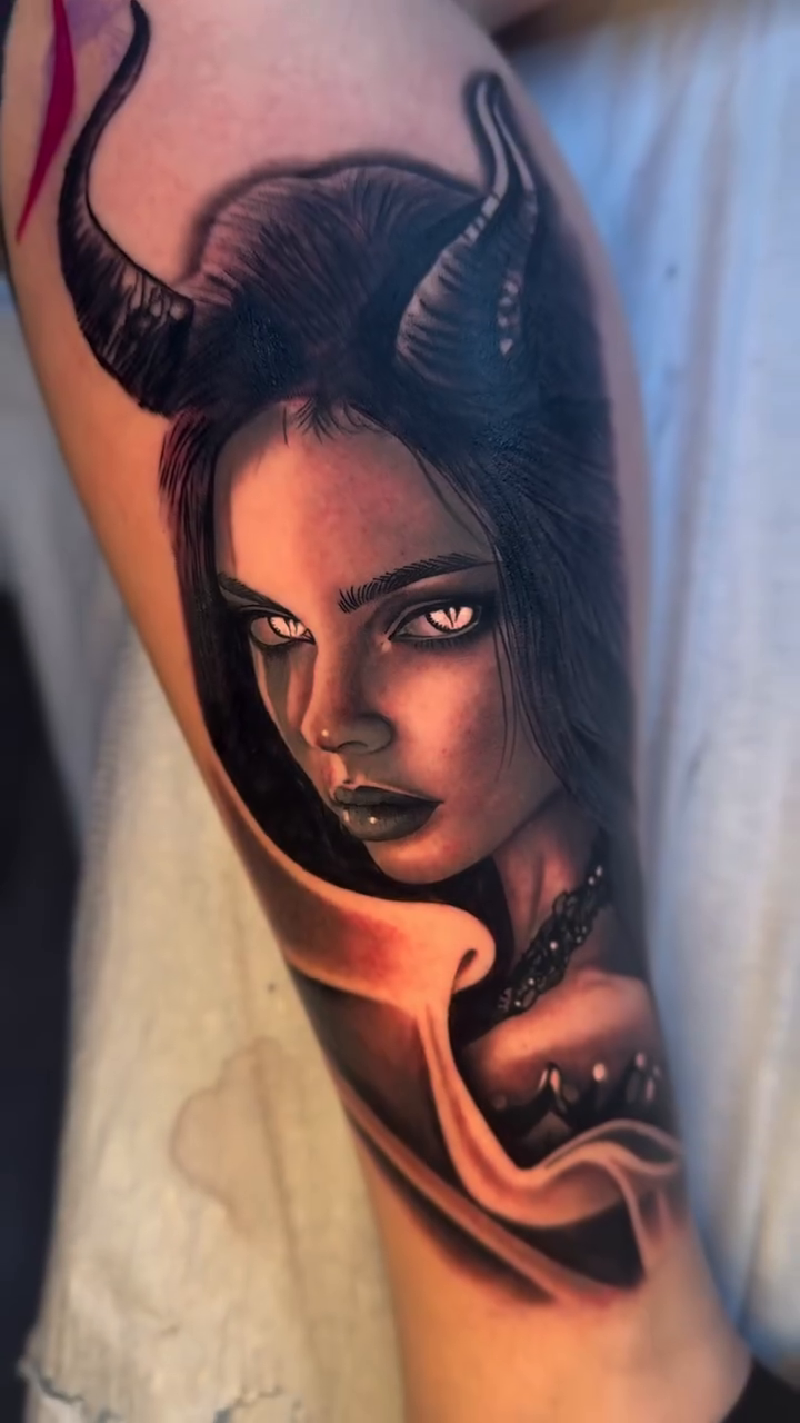 Portrait of a demoness with horns realism tattoo on the upper arm by Tay 🥀