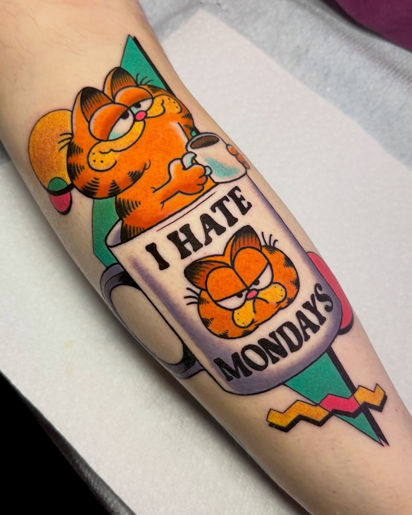 Garfield American traditional tattoo on the forearm by 𝔎𝔦𝔯𝔞 𝔅𝔦𝔰𝔥𝔬𝔭