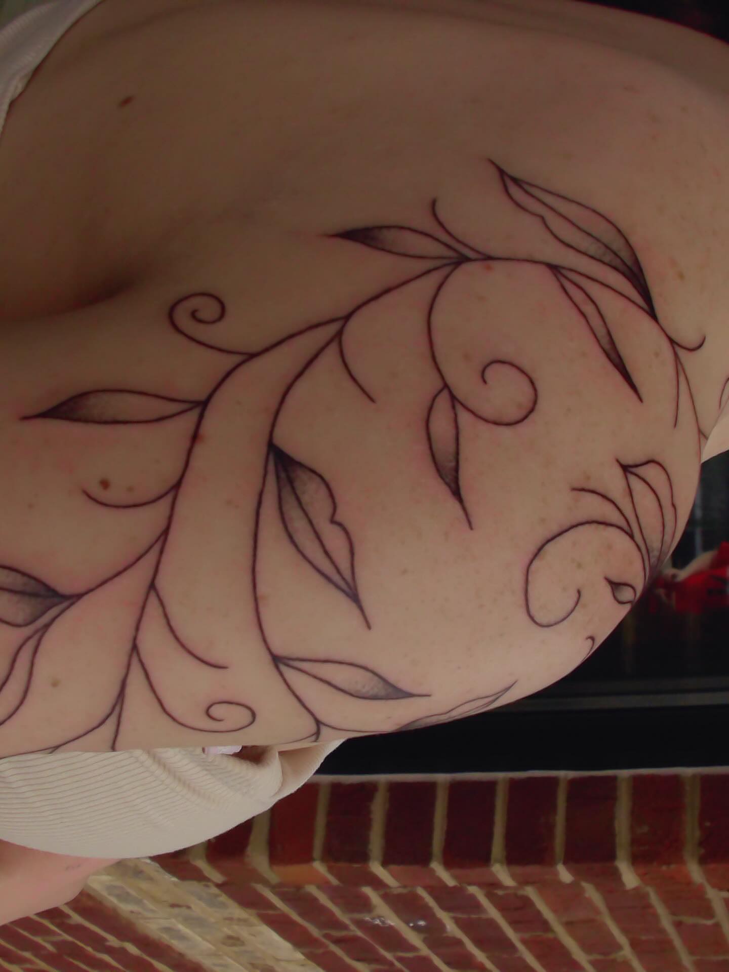 Floral design fine line tattoo on the shoulder by zoie rozay hannah