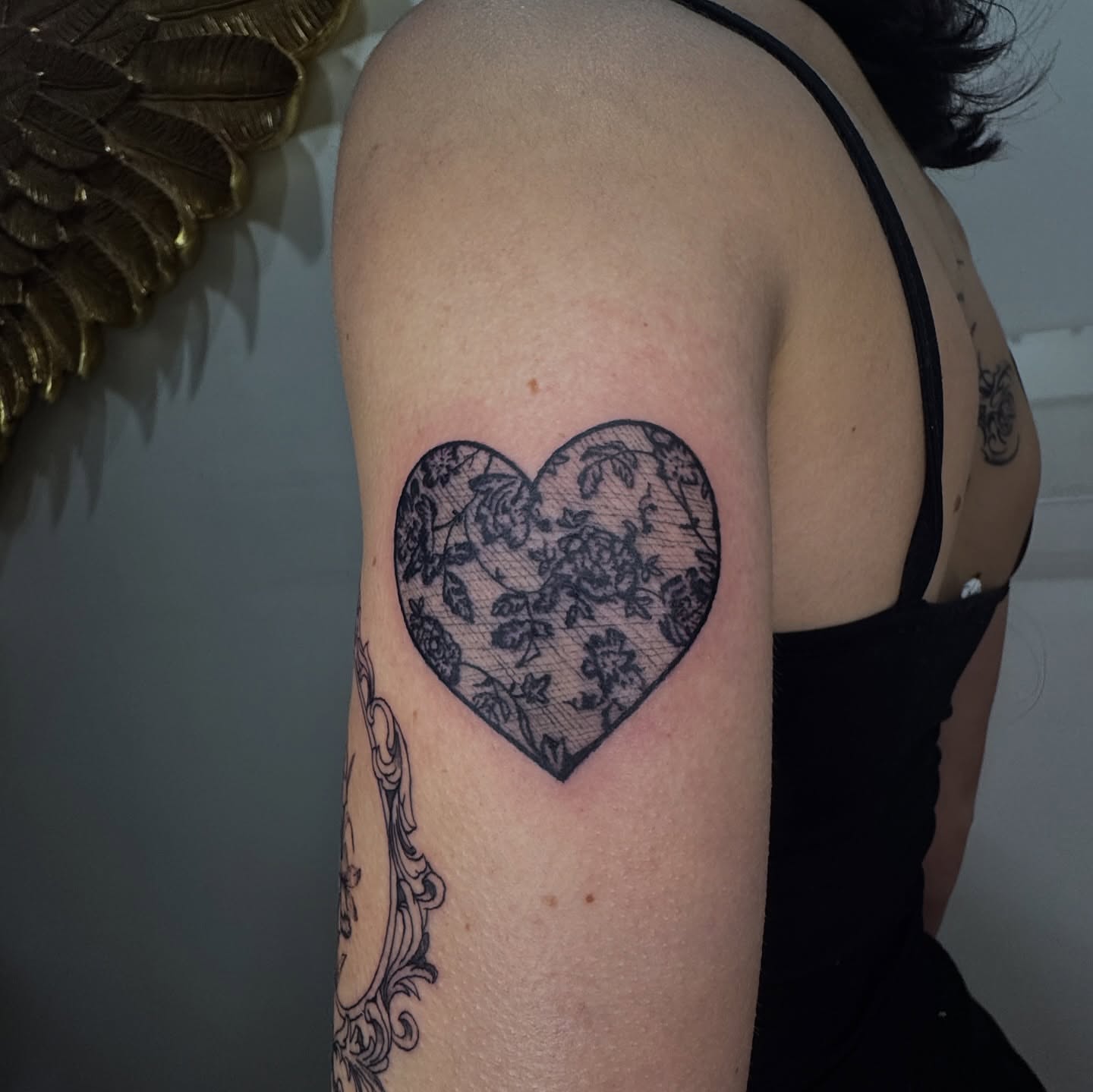 Lace heart black and grey tattoo on the upper arm by dev
