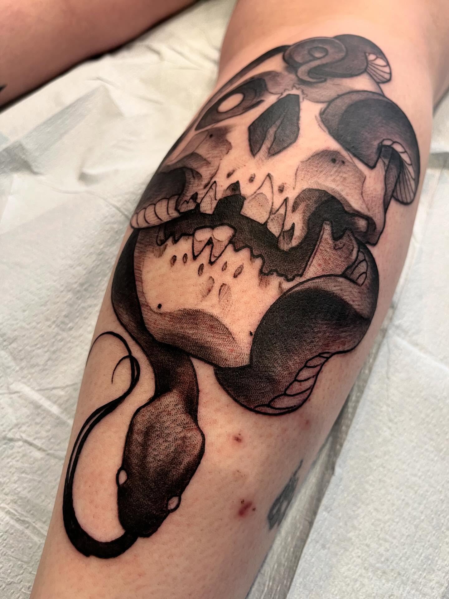 Snake and skull realism tattoo on the forearm by Ian White