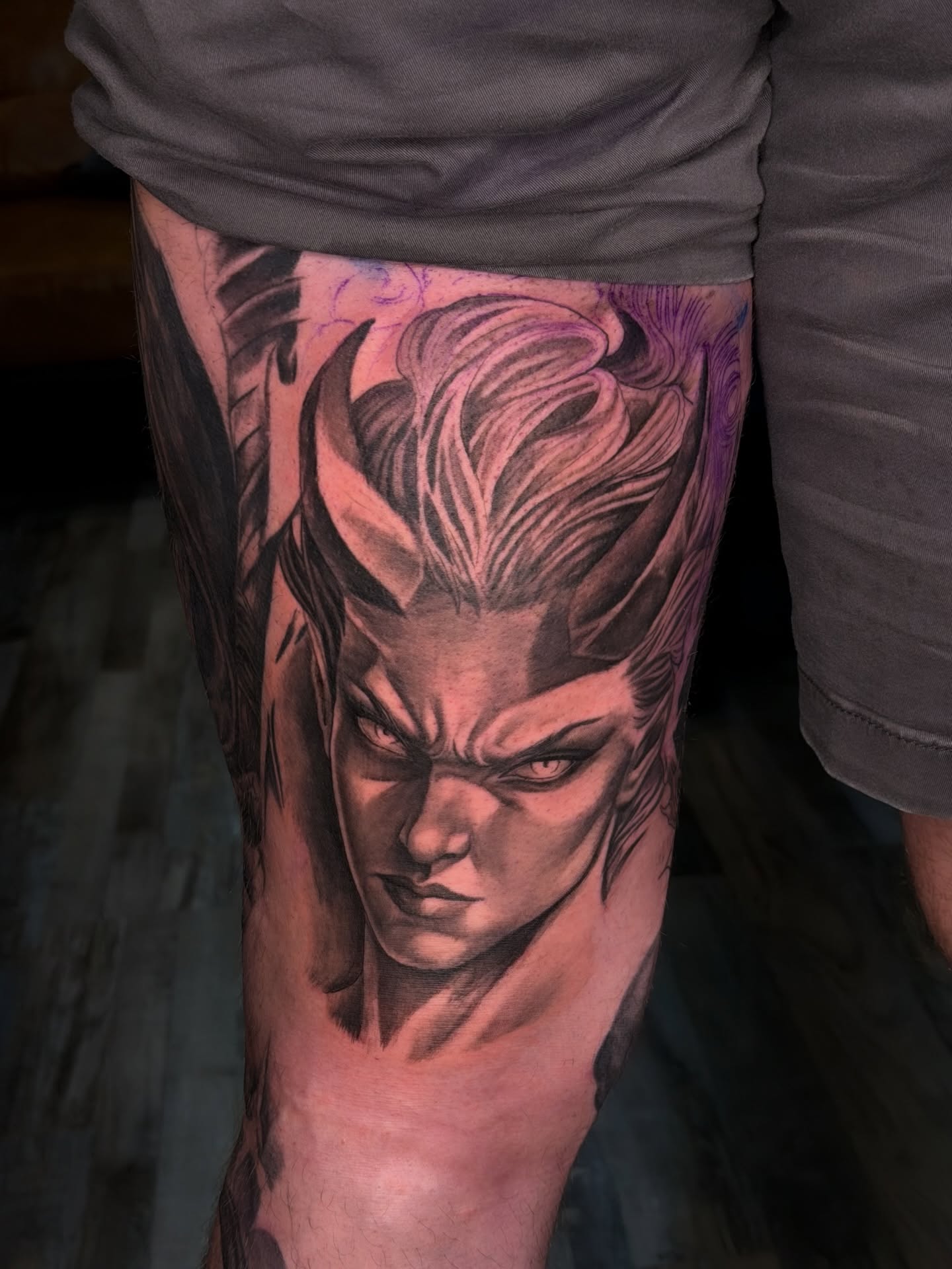 Angry man realism tattoo on the thigh by Caleb Moul