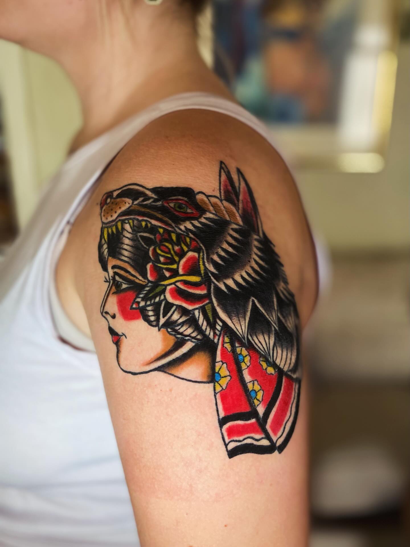 Geisha with wolf American traditional tattoo on the shoulder by Tommy O'Connell