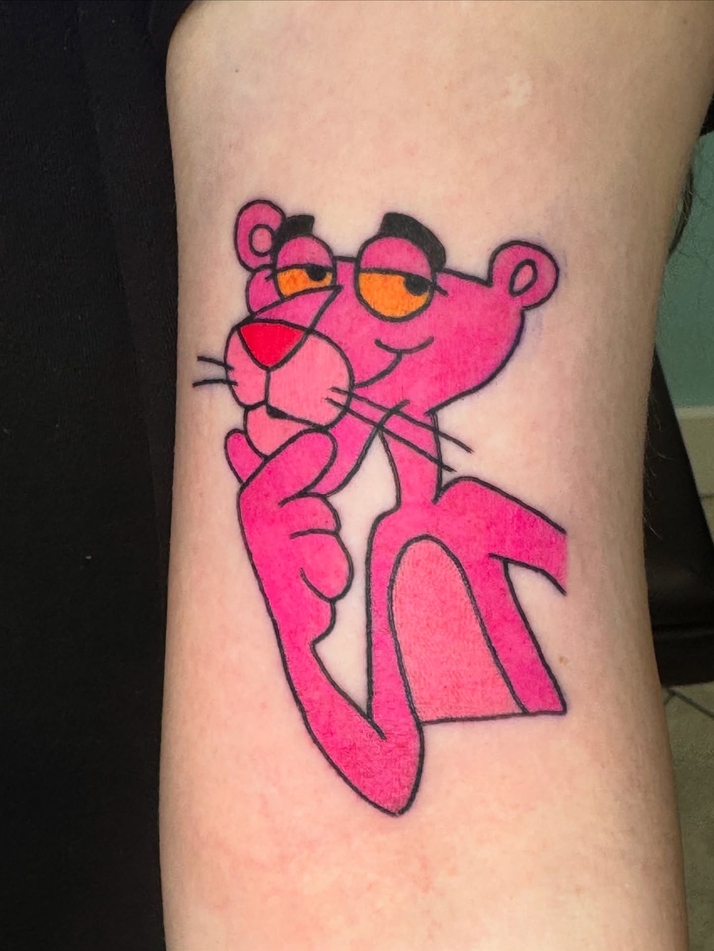 Pink panther new school tattoo on the forearm by Kenneth Gibson