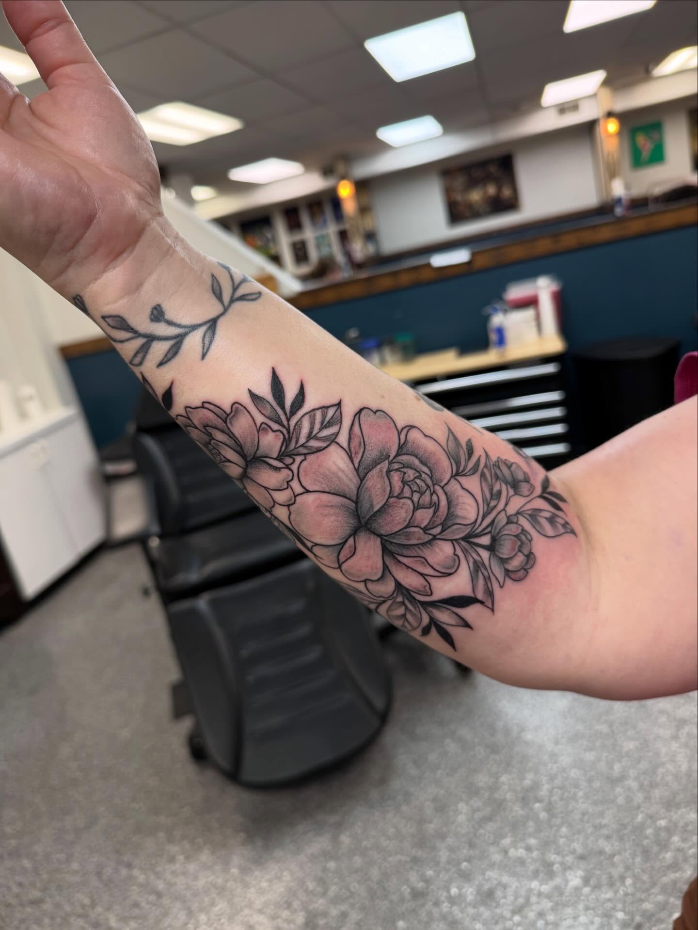 Floral bouquet black and grey tattoo on the forearm by “tatsbysabby”