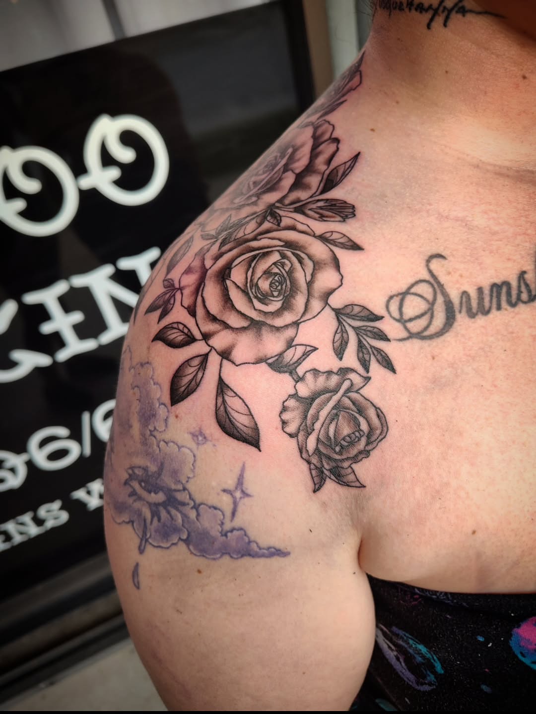 Roses and clouds realism tattoo on the shoulder by Julie MacDonald