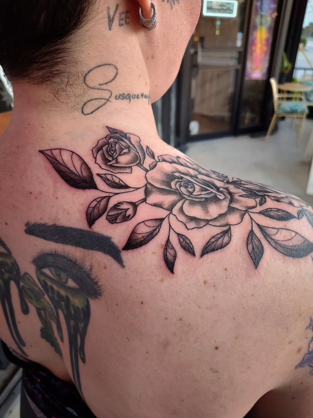 Roses black and grey tattoo on the shoulder by Julie MacDonald