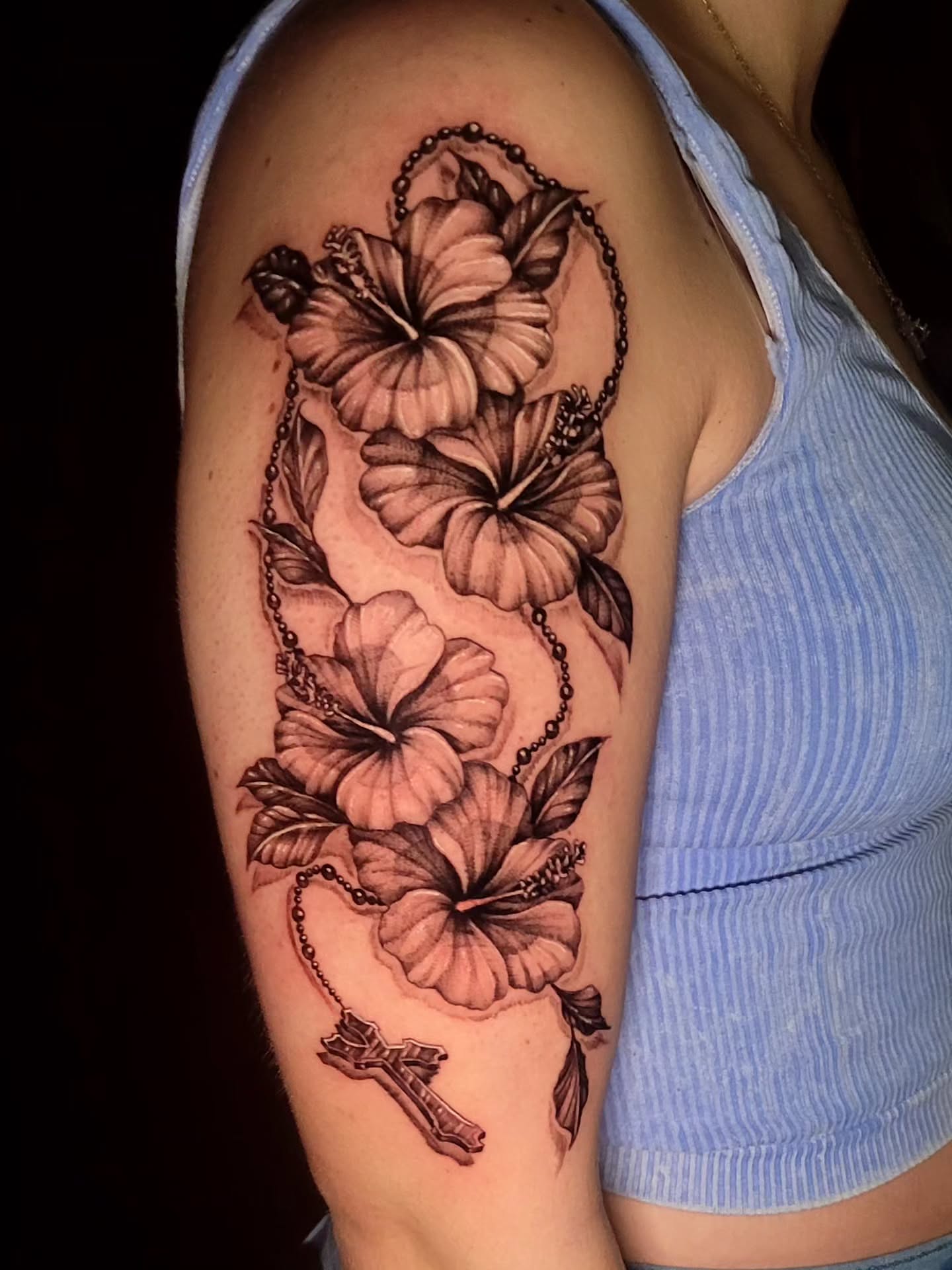 Hibiscus flowers black and grey tattoo on the upper arm by Tyler Monty