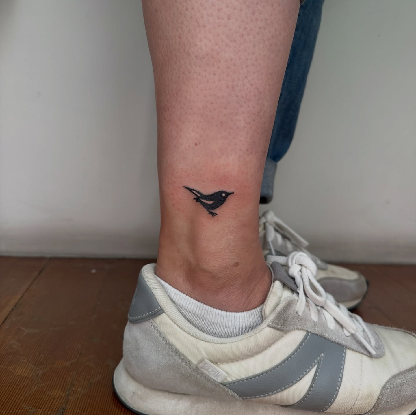 Bird minimalist tattoo on the calf by paulina